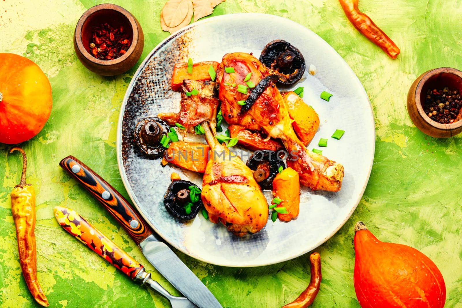 Chicken legs baked with pumpkin. Thanksgiving Day.