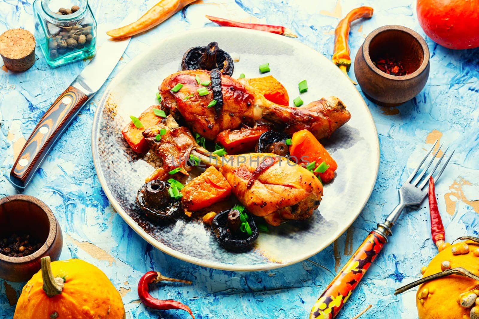 Chicken legs baked with pumpkin. Thanksgiving Day.