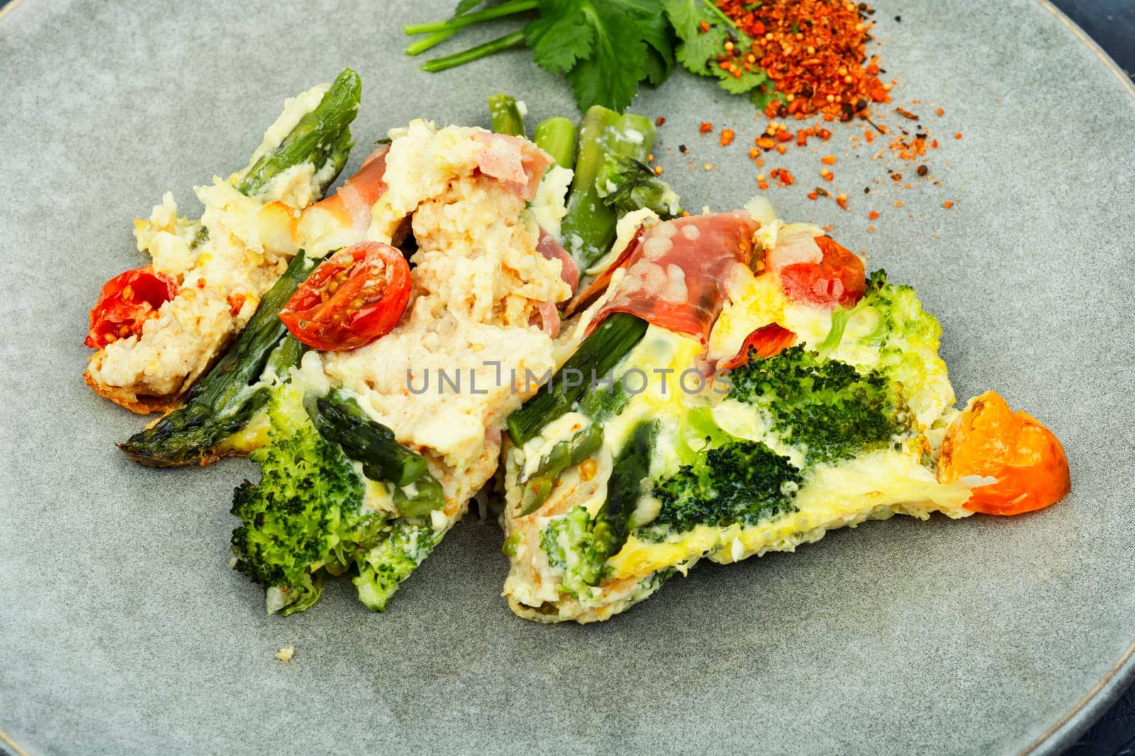 Asparagus wrapped in bacon with grated parmesan cheese