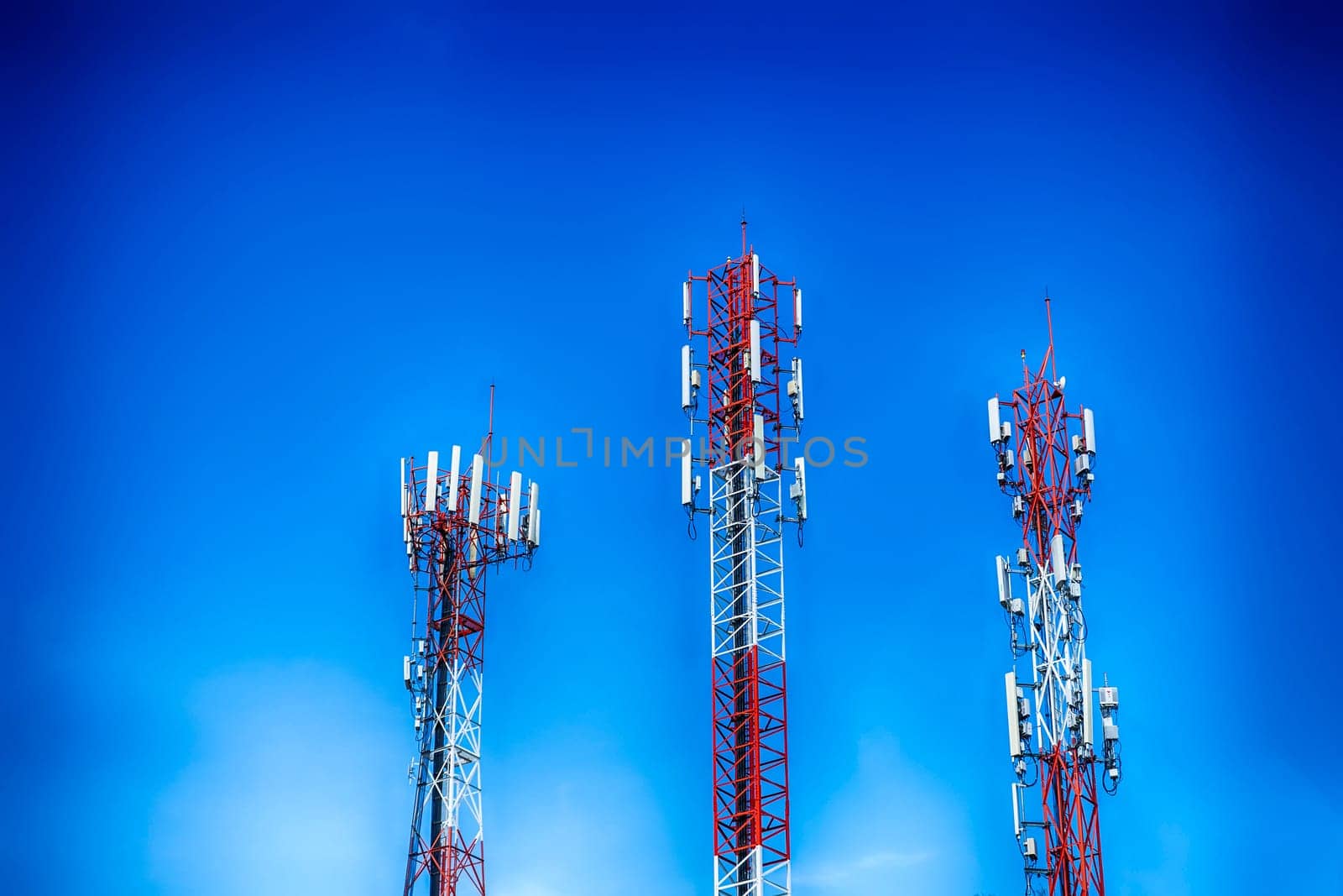 Three communication tower transmission  signal with blue sky