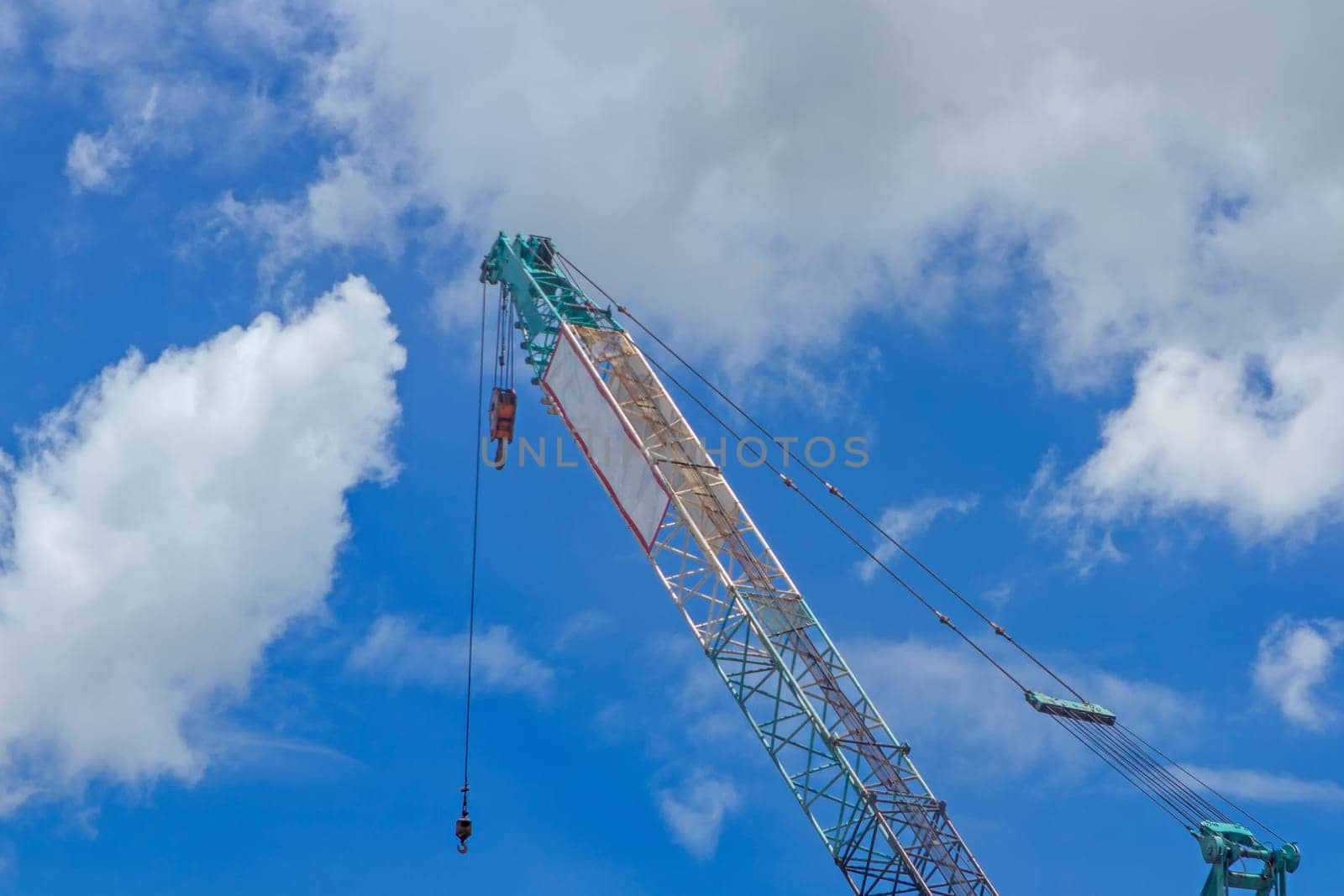 Crane lift of  green on blue sky background