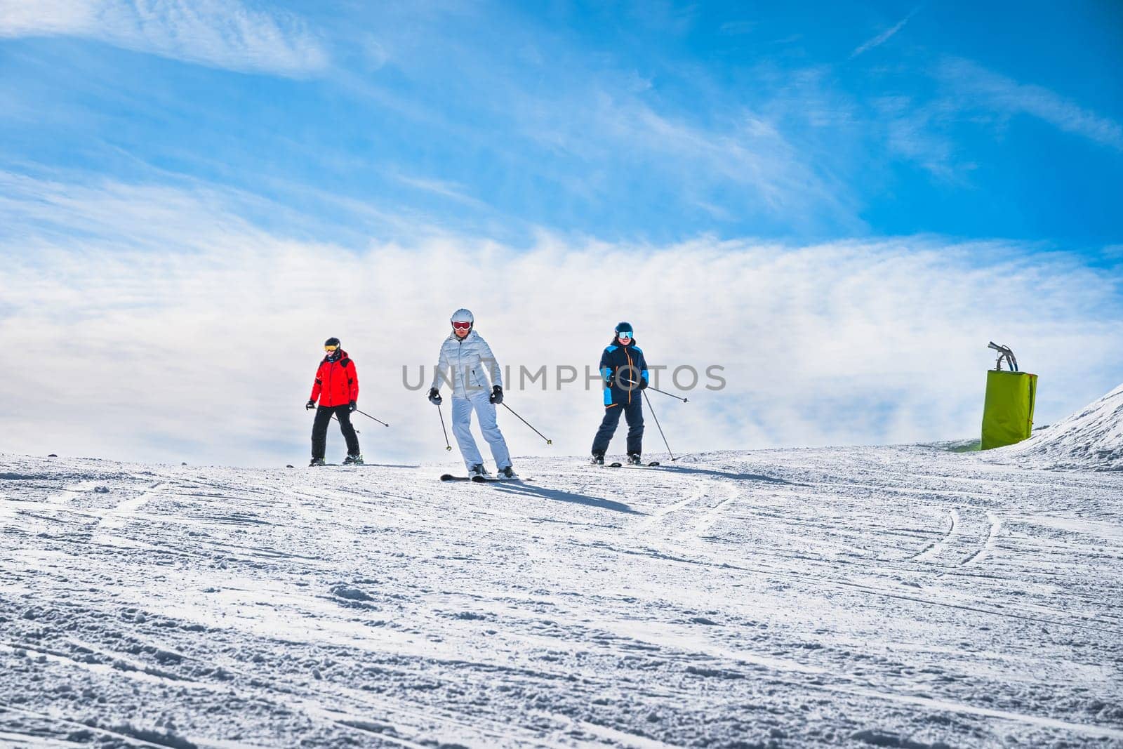 Man and woman skiing down the ski slope or piste in Pyrenees Mountains. Winter ski holidays in El Tarter, Grandvalira, Andorra