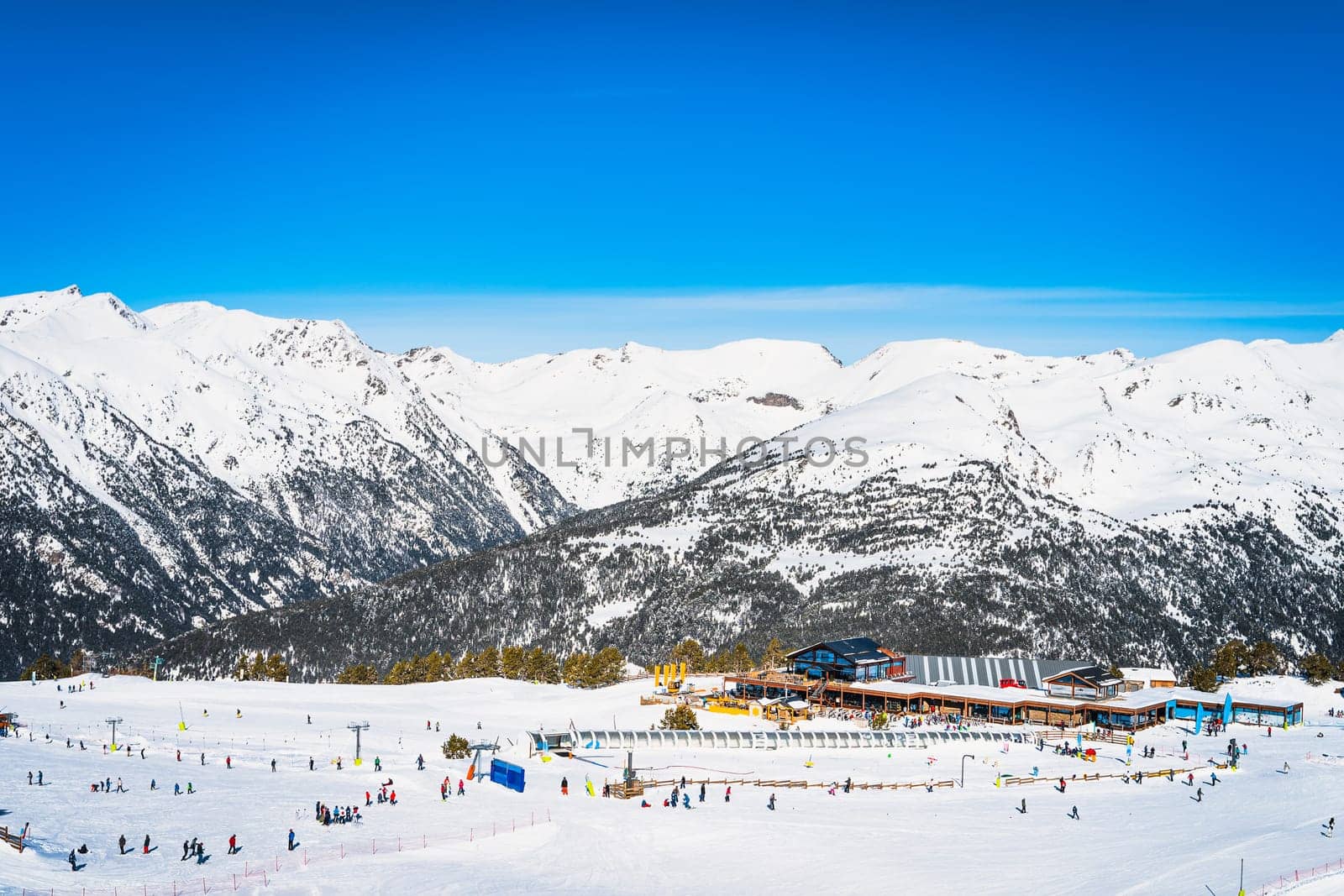 People, families, skiers and snowboarders relaxing and having fun in winter at Soldeu ski lifts cross centre, Grandvalira, Andorra, Pyrenees Mountains