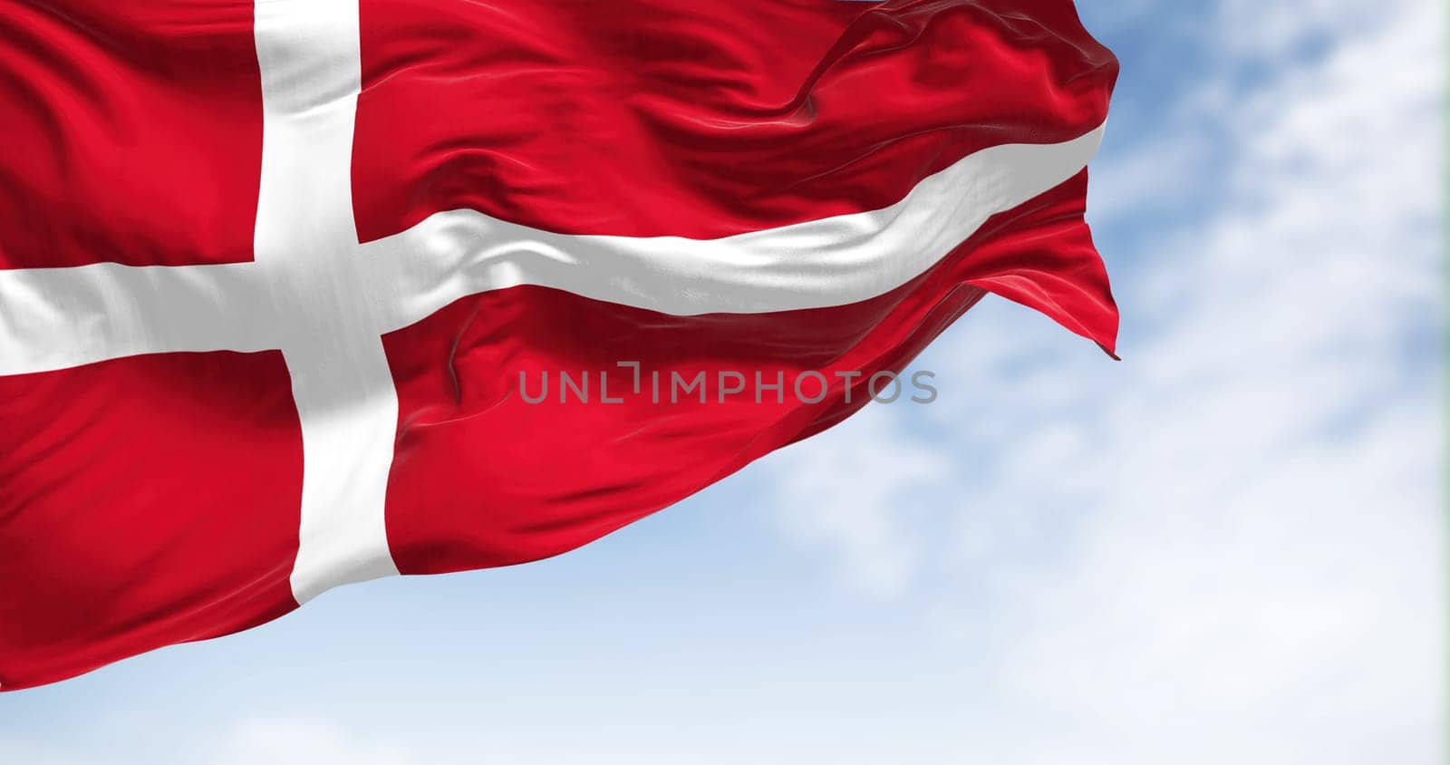 Close-up view of the Denmark national flag waving in the wind. The Kingdom of Denmark is a Nordic country in Northern Europe. Fabric textured background. Selective focus. 3d illustration