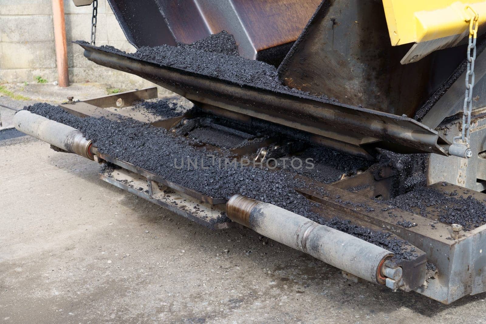 Paver finisher, asphalt finisher or paving machine placing a layer of asphalt. Repaving