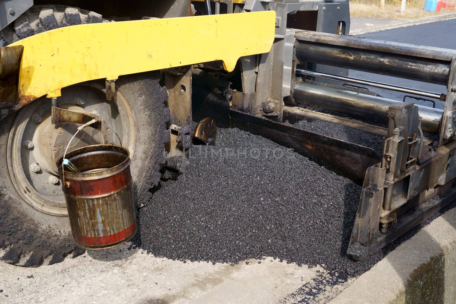 Paver finisher, asphalt finisher or paving machine placing a layer of asphalt. Repaving