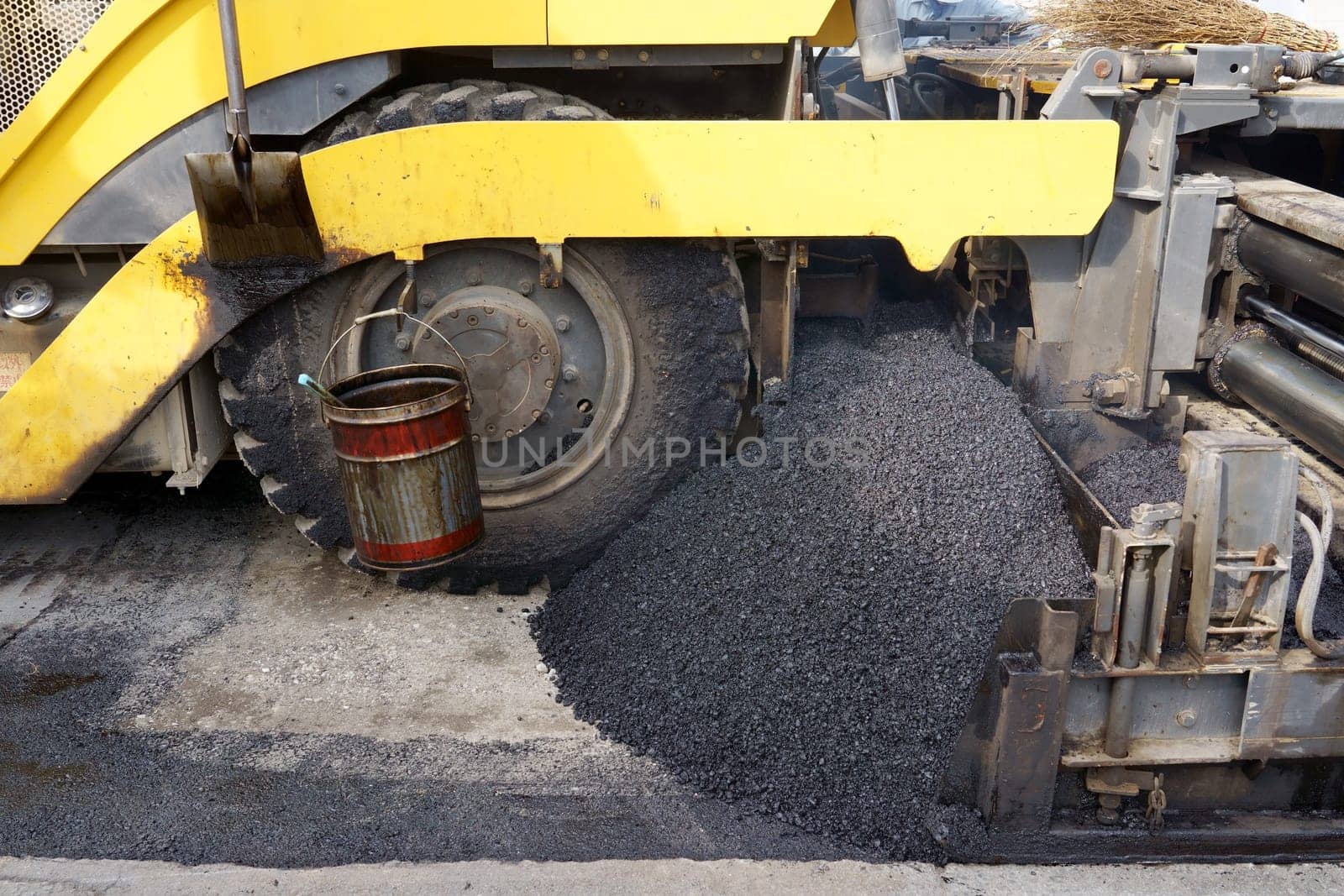 Paver finisher, asphalt finisher or paving machine placing a layer of asphalt. Repaving