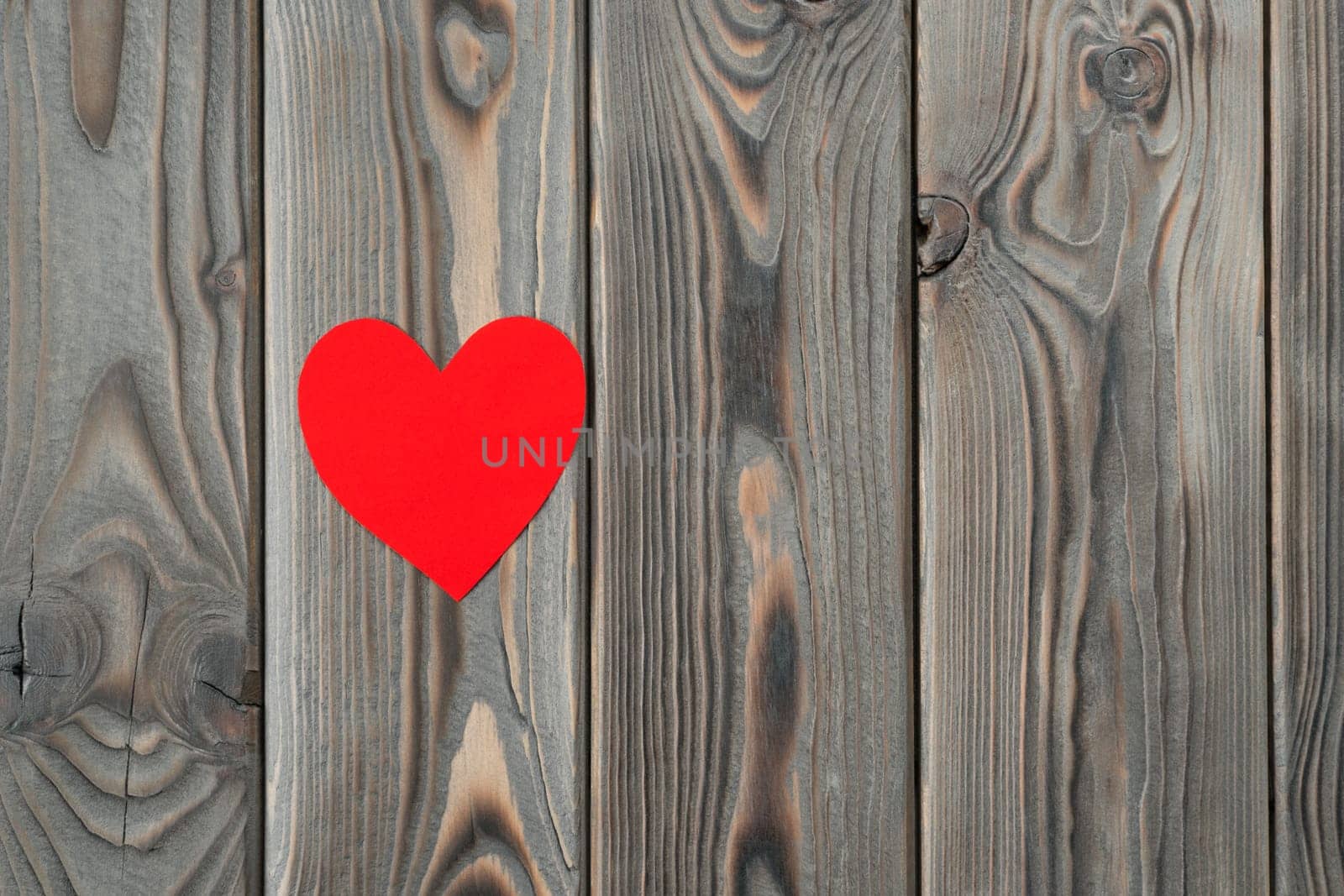 Little red heart shape on dark wooden background. Saint valentines, love greeting card and invitation on holidays. Happy marriage, wedding, 14 February or mothers day. Copy space, top view, flat lay