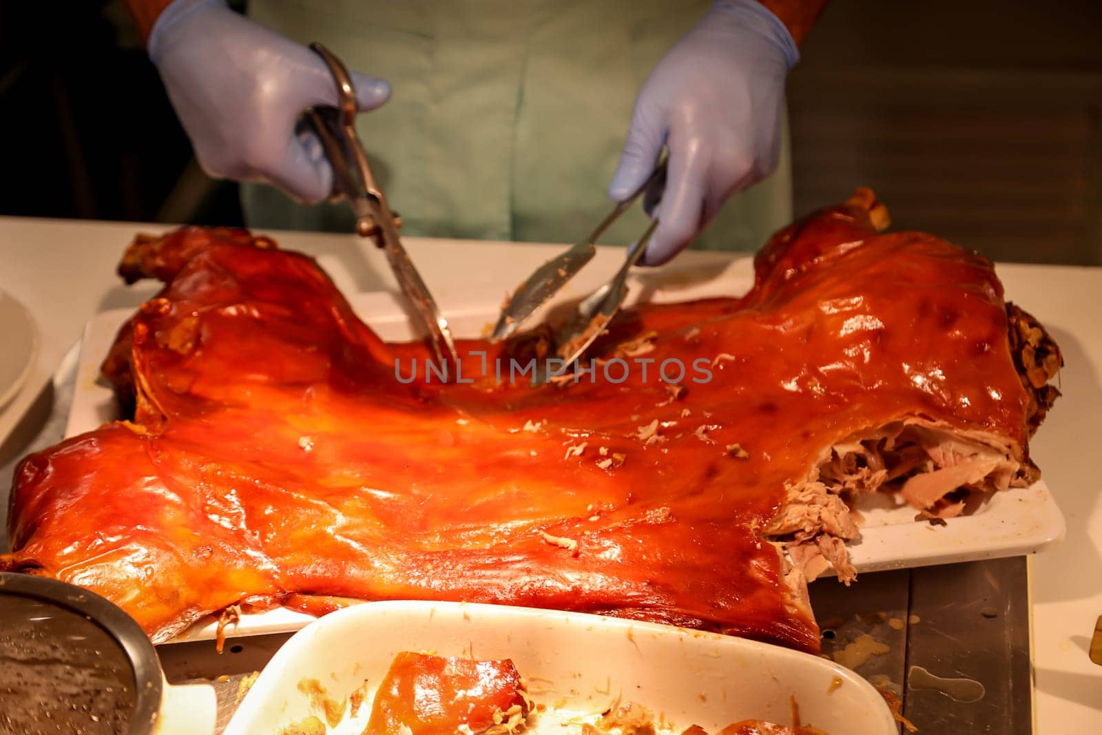 The dissection of a roasted suckling pig at a buffet.