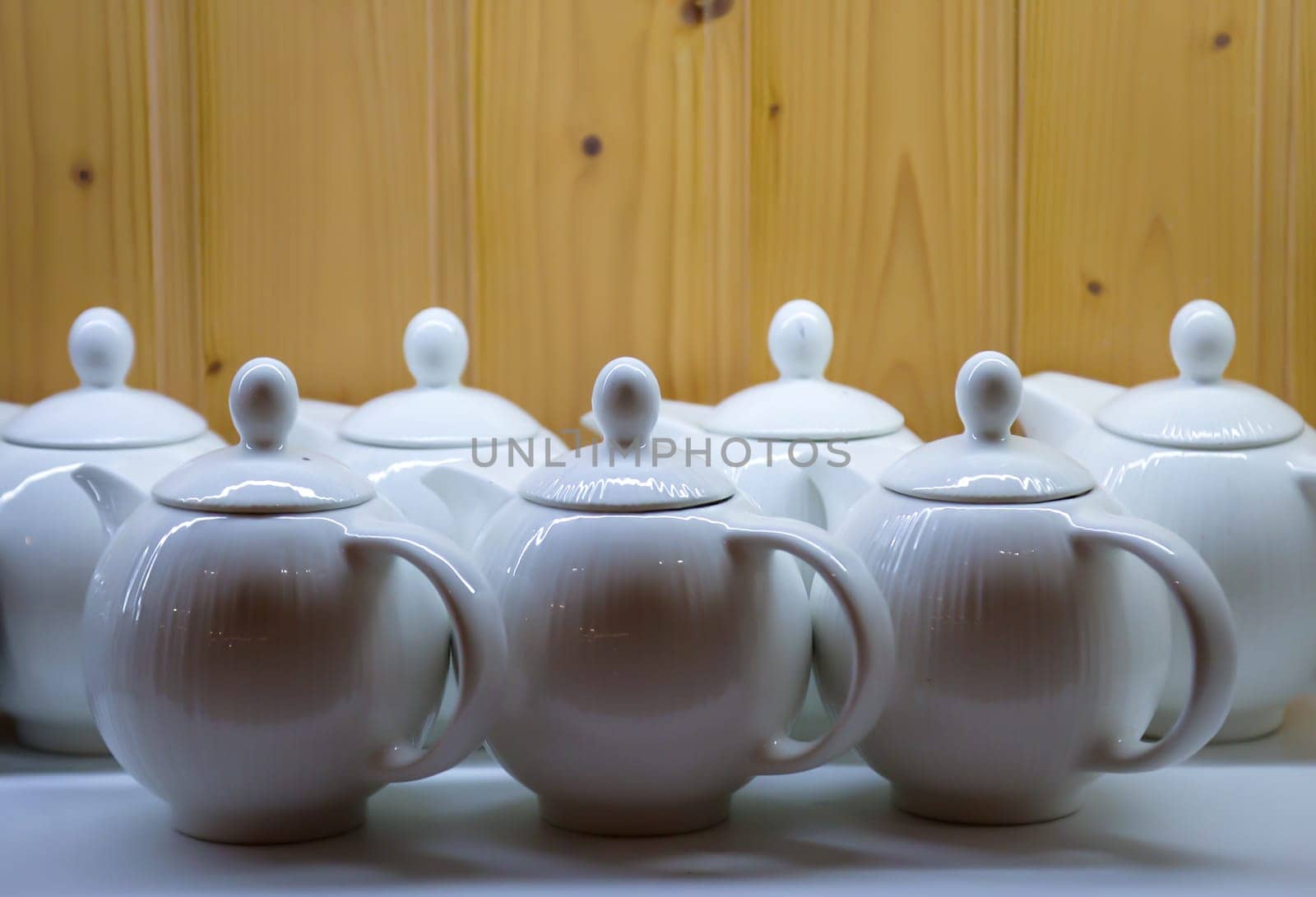 Many coffee pots stand side by side in one compartment.