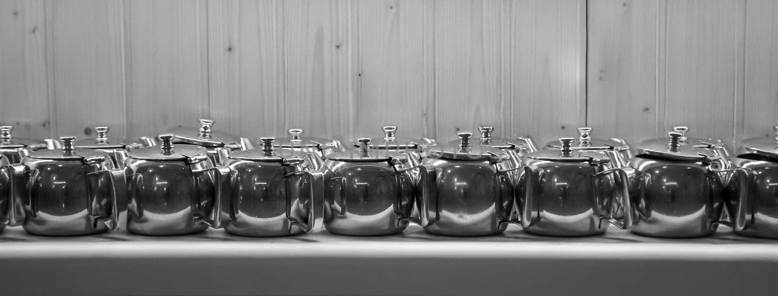 Many coffee pots stand side by side in one compartment.