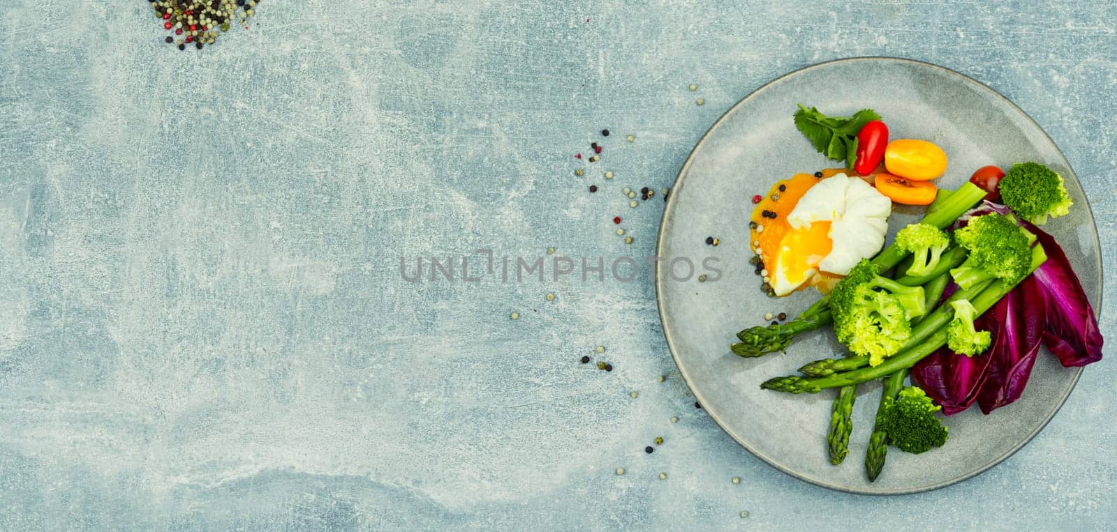 Salad with asparagus, lettuce, tomato and poached egg. healthy lunch