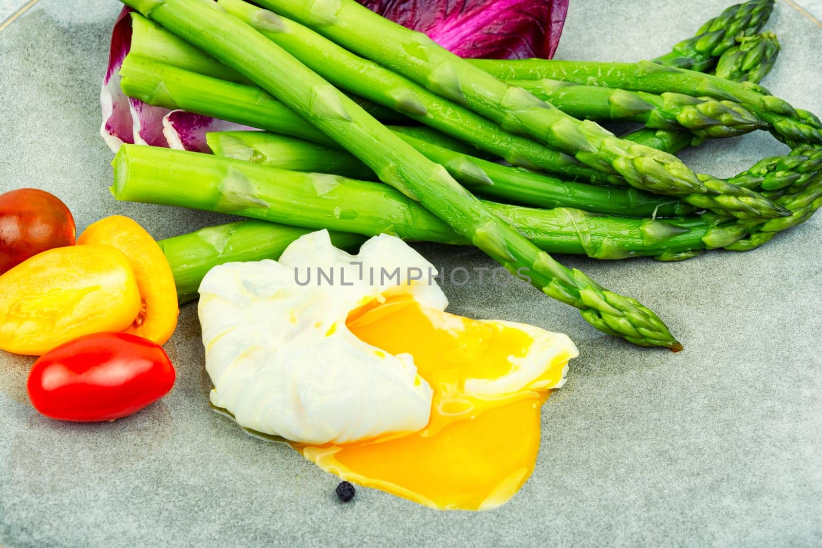 Salad with asparagus, lettuce, tomato and poached egg. healthy lunch