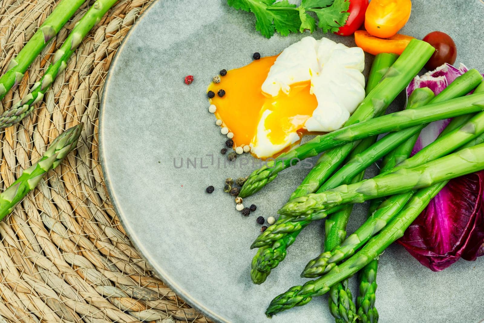 Salad with asparagus, lettuce, tomato and poached egg. healthy lunch