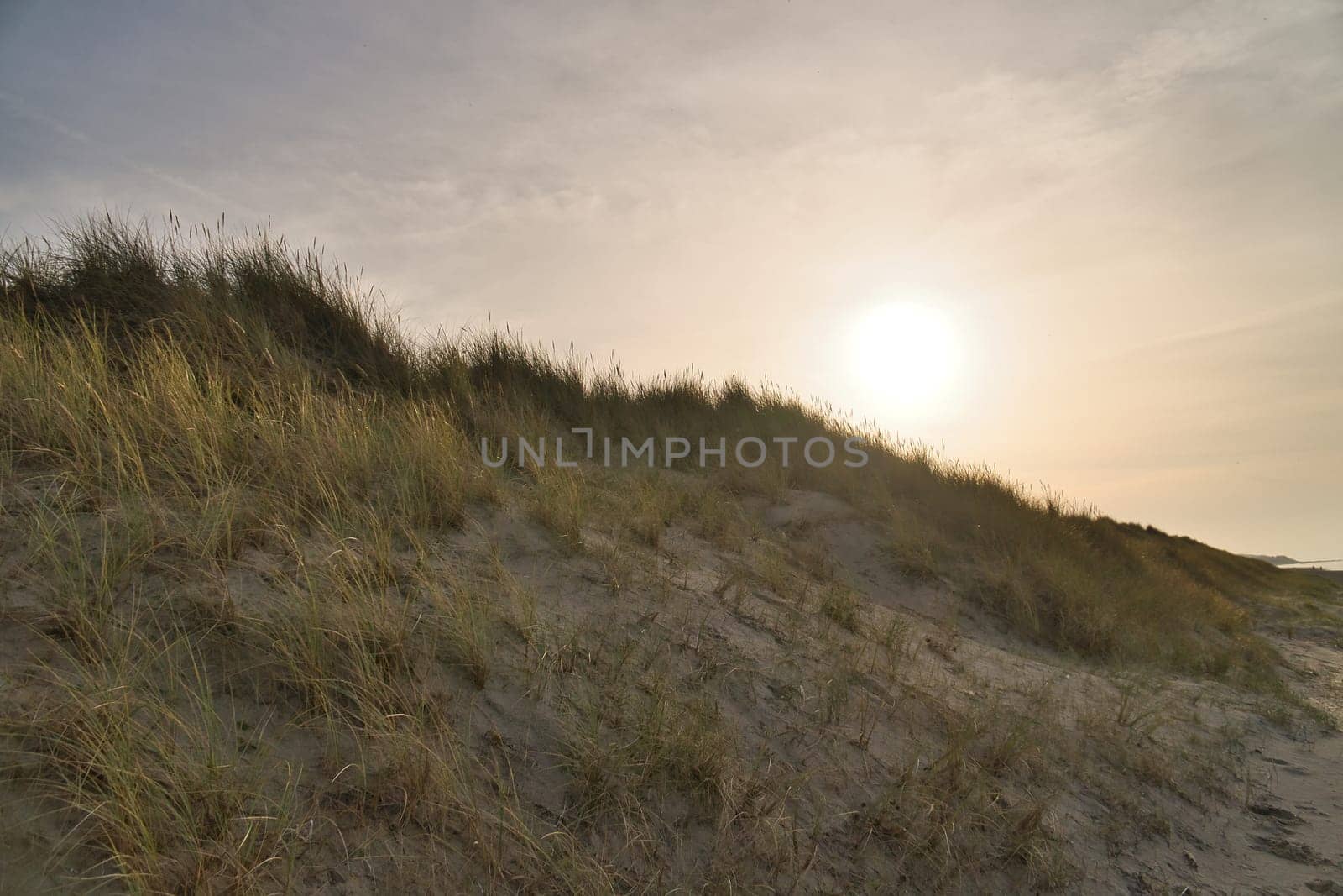 Beach crossing in Denmark by the sea. Dunes, sand water and clouds on the coast. Trip to the Baltic Sea. Vacation on the beach. Scandinavia landscape