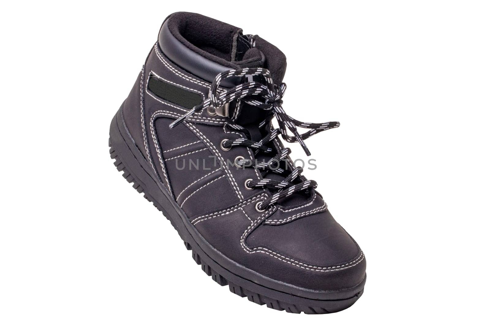 Winter boots. Close-up of a single elegant black leather winter boots with laces and rivets isolated on white. Clipping path. Macro. Autumn shoe fashion for child boy.
