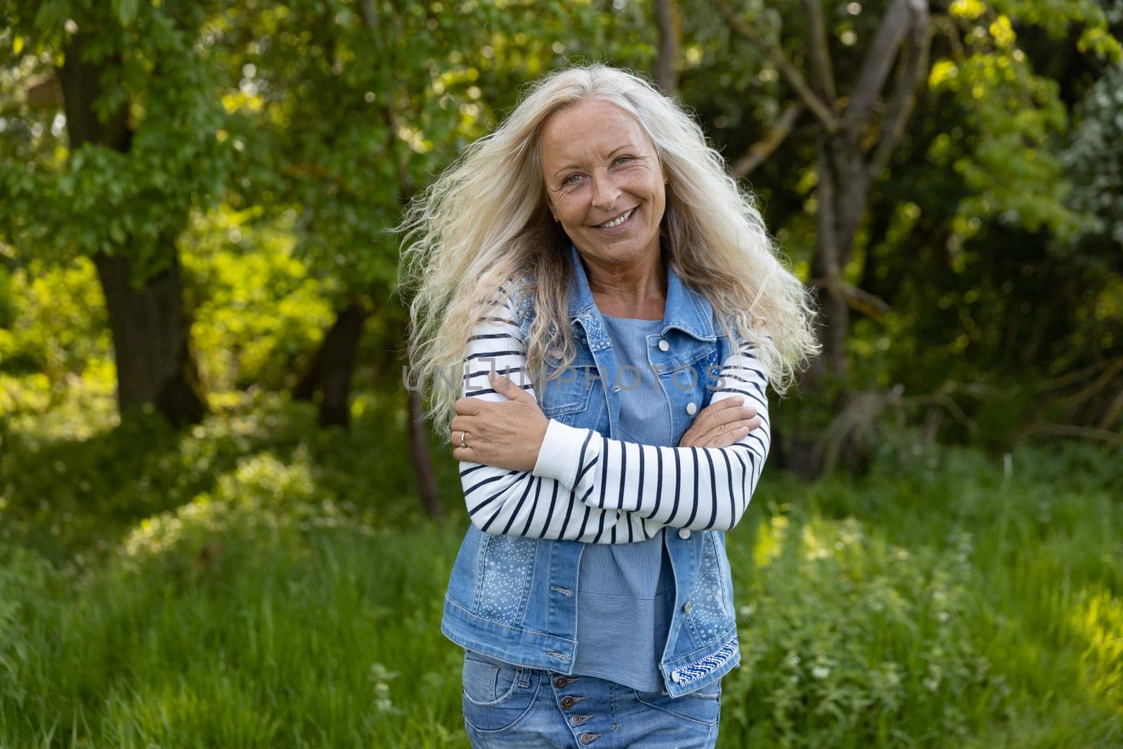 Beautiful Woman crossed her arms in a puplic park on a sunny day