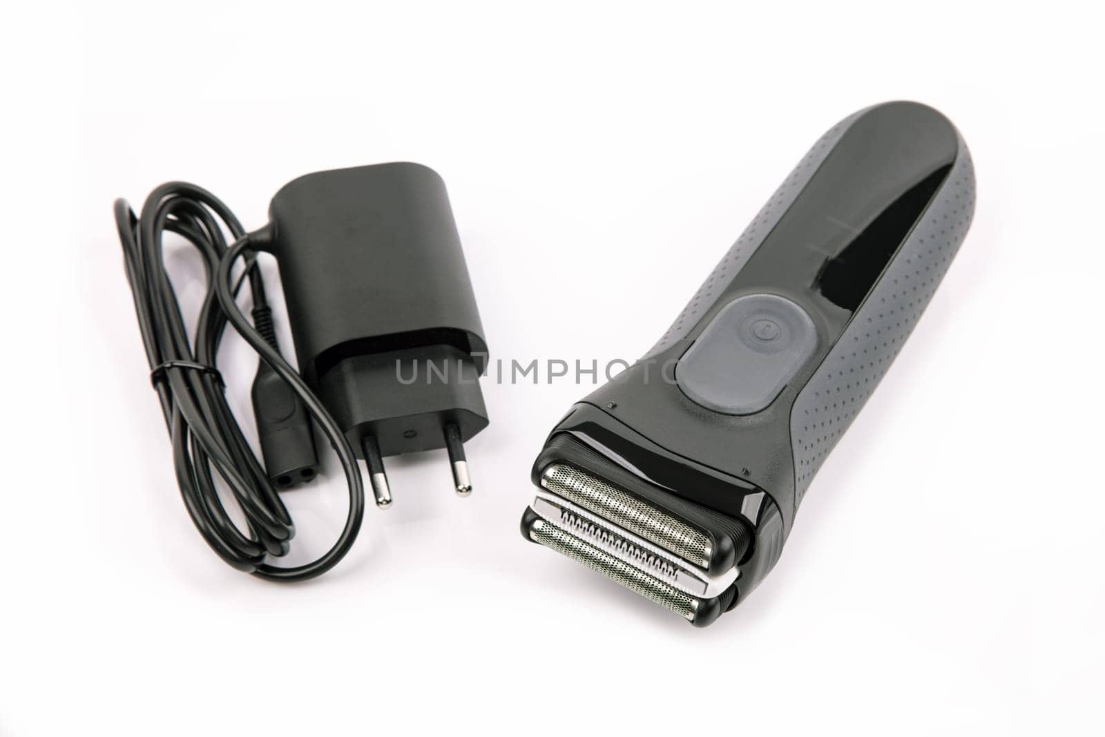 Power Adapter and Electric Shaver over bright background