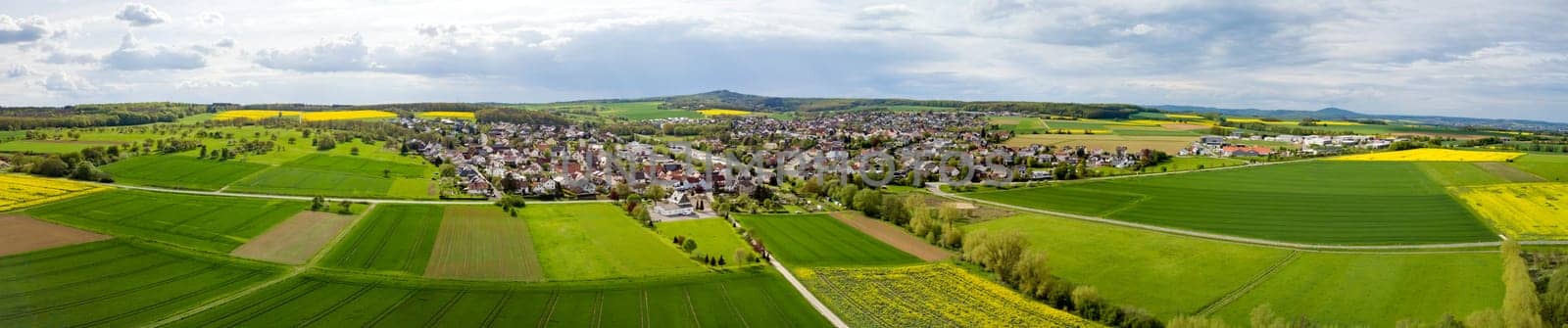 Panoramic Drone shot from german landscape with meadows and small village
