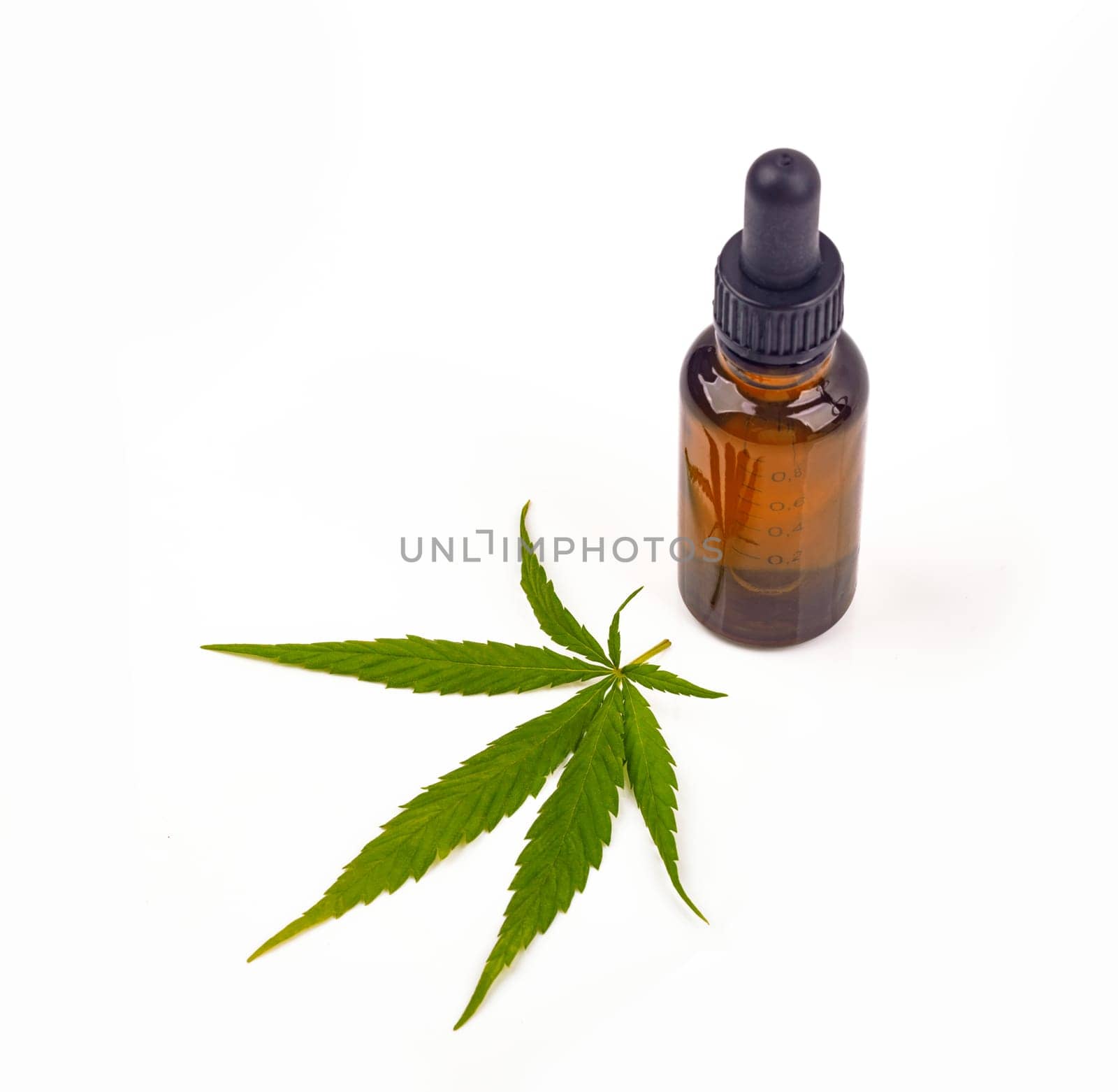 Cannabis oil hemp oil with fresh cannabis leafon bright background
