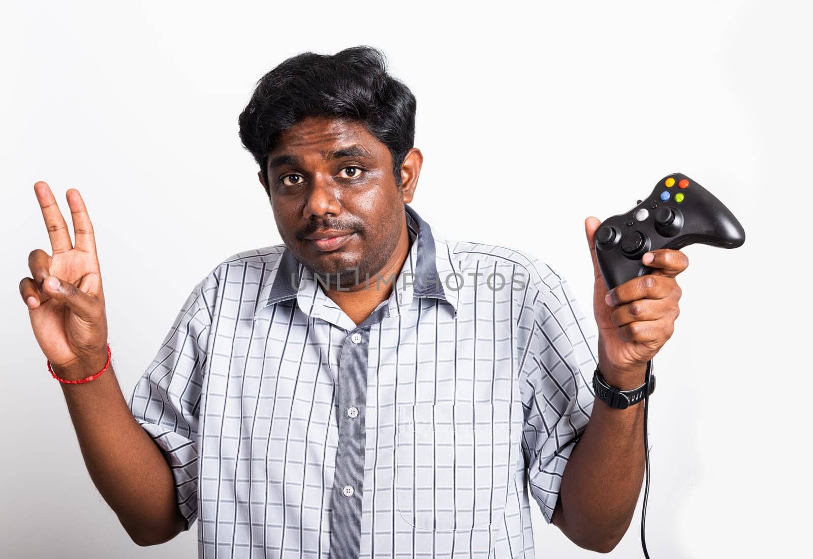 Asian happy portrait young black man funny use hand playing video game pad joystick controller, studio shot isolated on white background