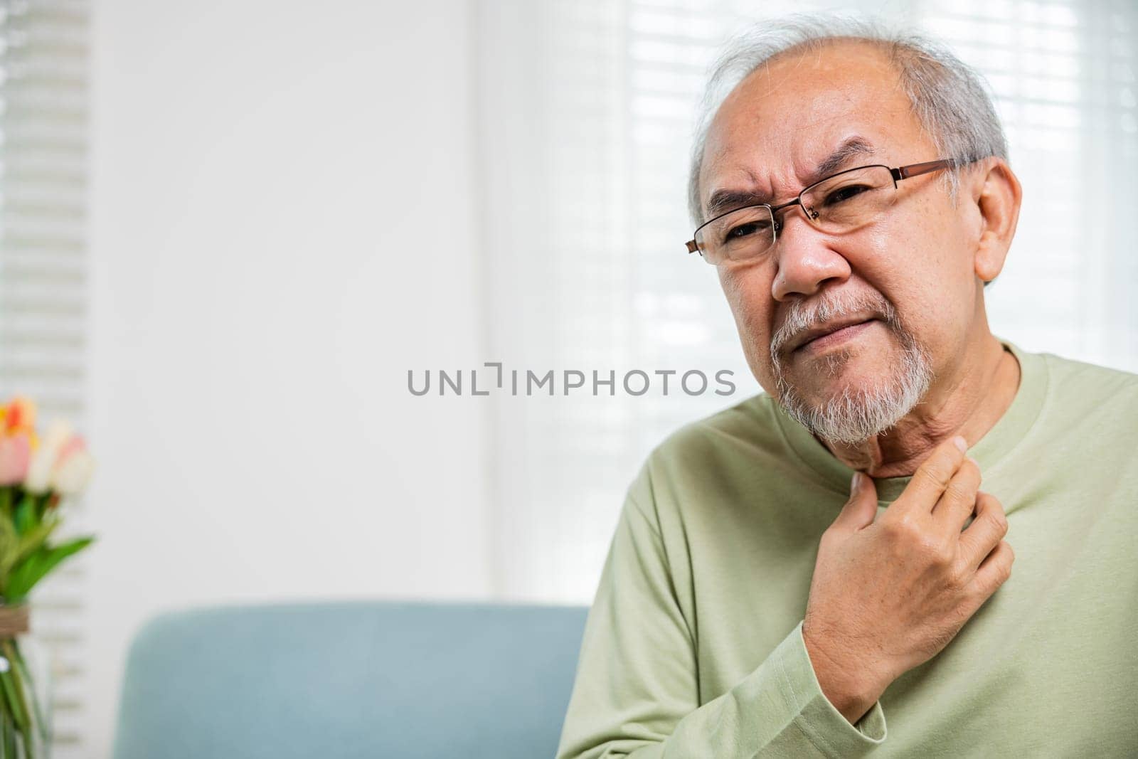 Asian old man painful in the sore throat, retirement senior man feeling pain use hands holding neck, Elderly people have dysphagia due to eating, Health care and medicine concept