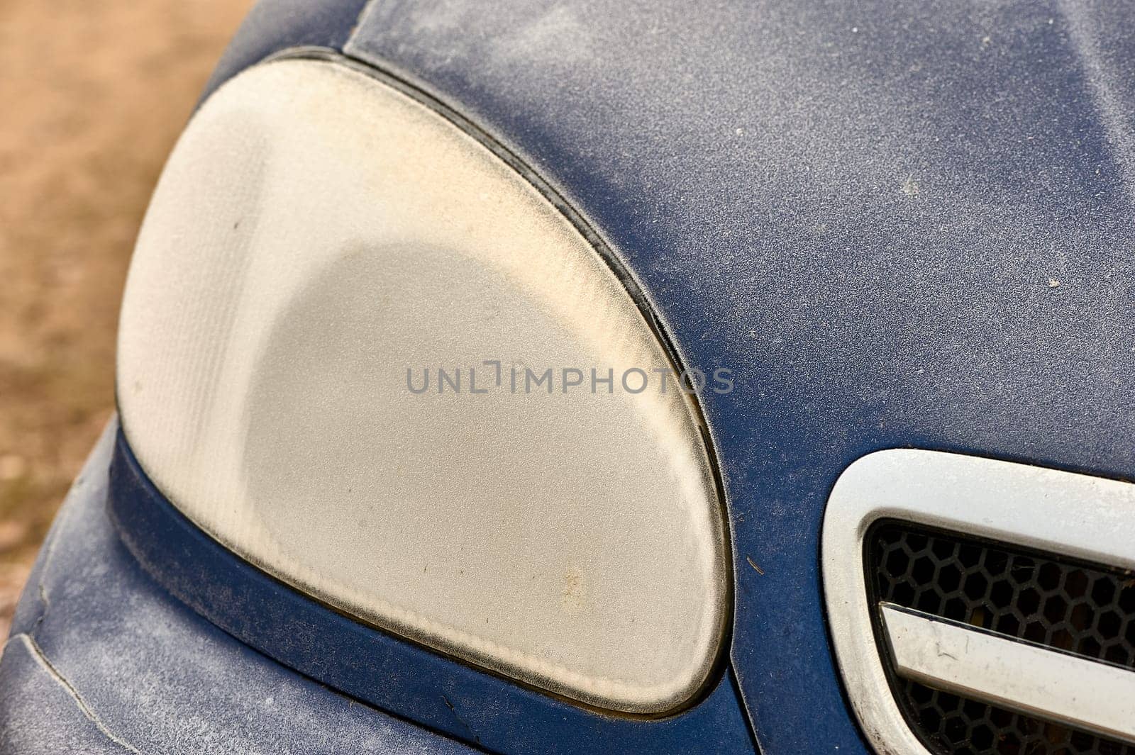 the front headlight of the car covered with frost. High quality photo
