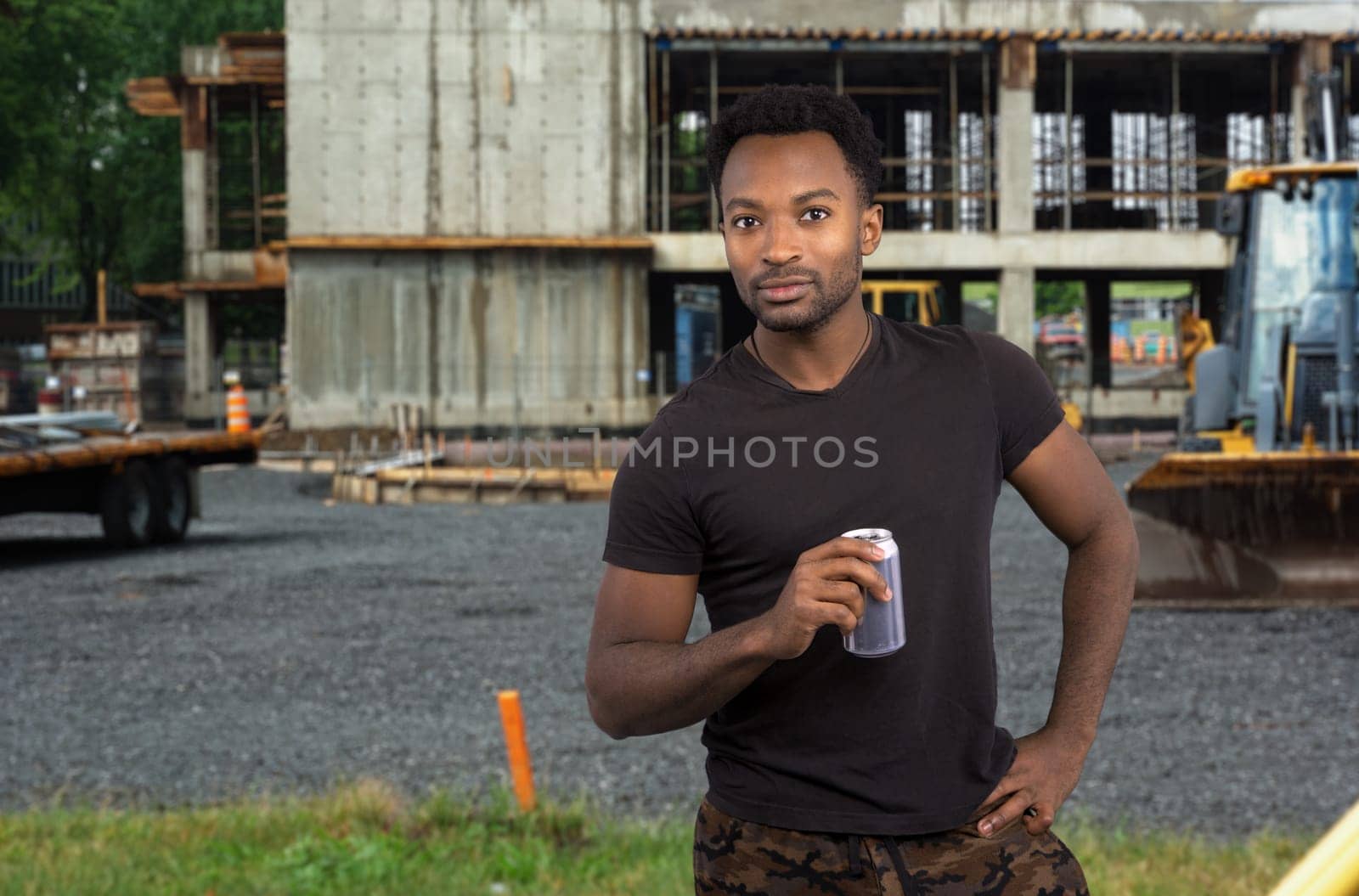 worker on break drinking soda at construction site job break tired man overworked