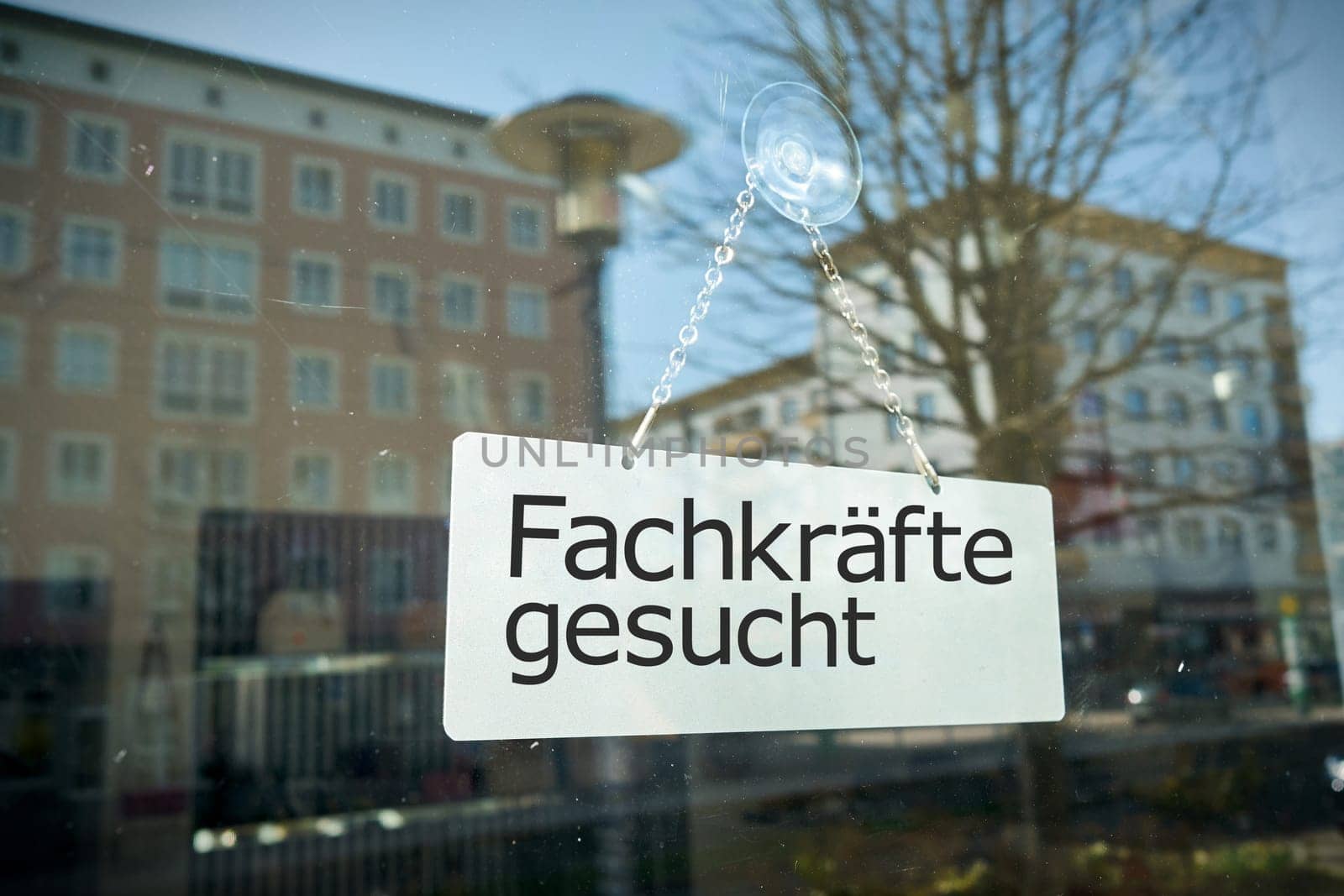 Sign on shop window with the german inscription Fachkrafte gesucht. Translation: Skilled workers wanted