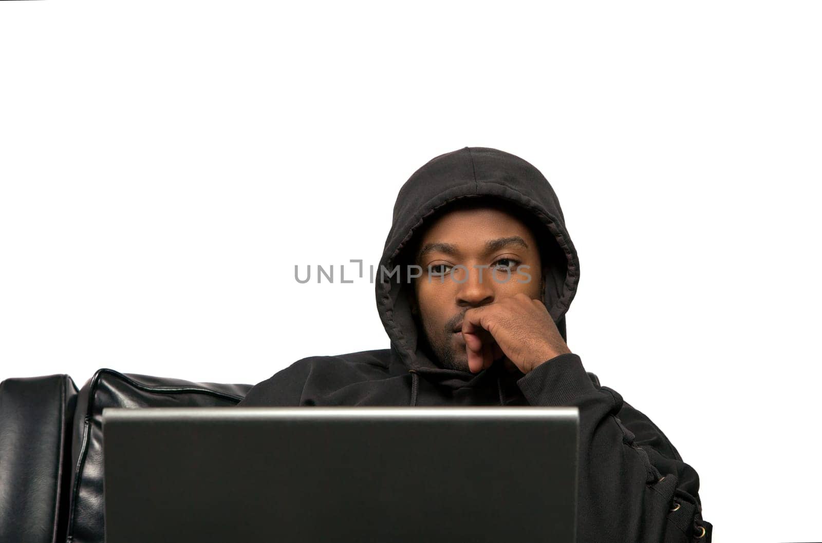 young man using laptop computer black sofa wearing hoody on white isolated background