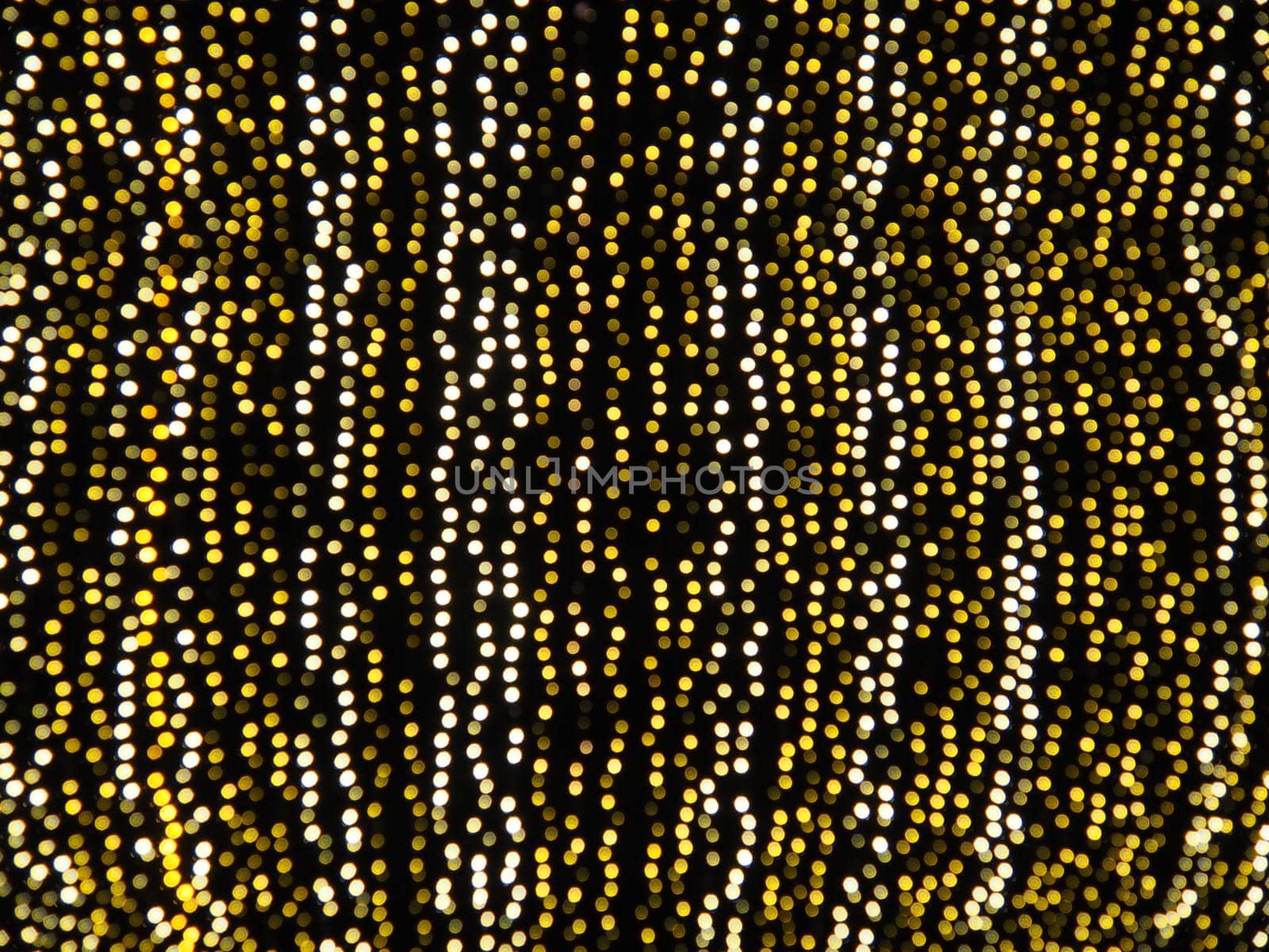 Hanging garlands against the background of the night sky. Festive decoration of city streets. Garlands of yellow, white and gold lights and bulbs. Beautiful background for New Year, Christmas holiday