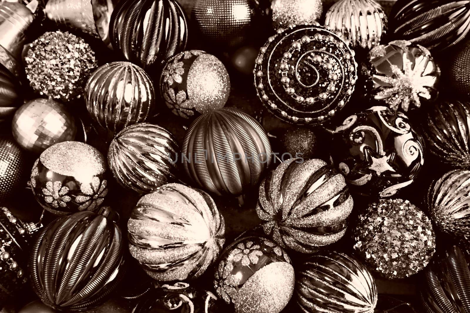 Christmas flat lay with Xmas decorations and holiday beautiful balls. Christmas tinsel. Happy New Year and Merry Christmas. Black and white monochrome photo with sepia filter. Still life background.