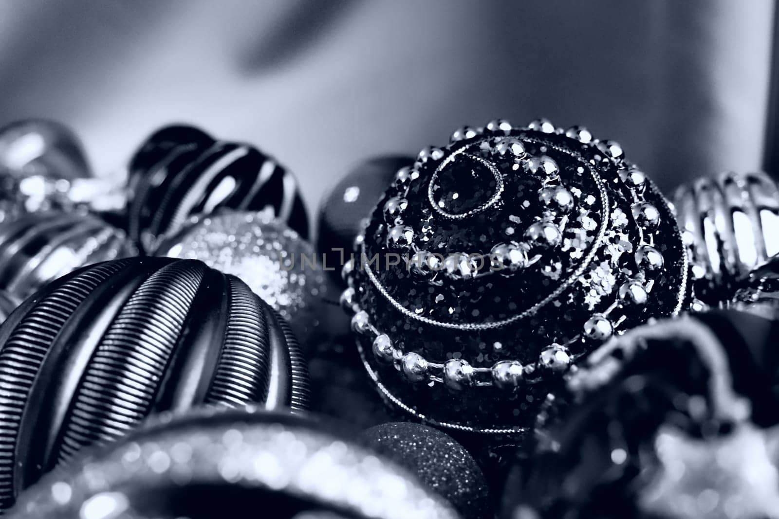 Christmas flat lay with Xmas decorations and holiday beautiful balls. Christmas tinsel. Happy New Year and Merry Christmas. Black and white monochrome photo with blue filter. Still life background.