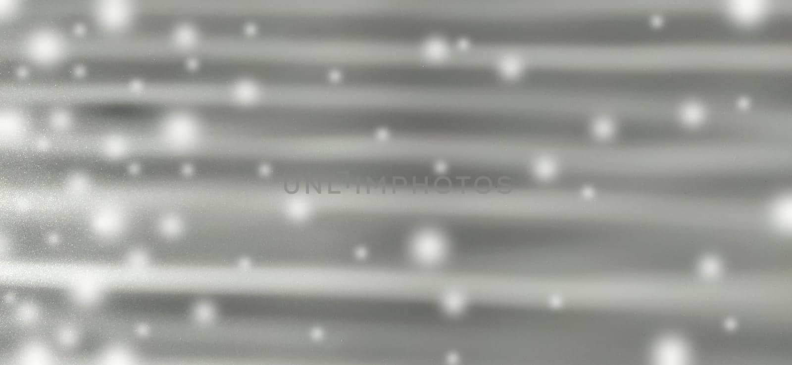 horizontal rays and white bokeh on a gray glittering background. New Year or Christmas background with white spots like flying snow. Moon rays. Blurred image