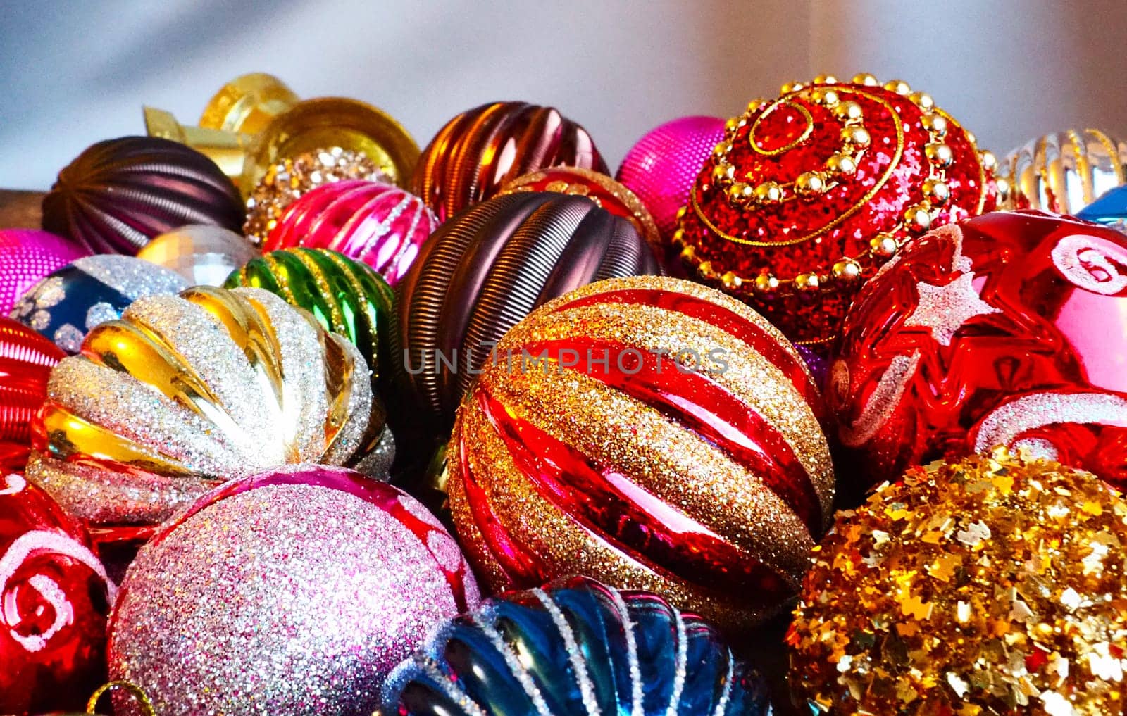 Christmas decorations. Beautiful red, golden, yellow balls with sparkles and stripes. Preparing for the New Year and Christmas holidays. Beautiful decorations. Flat lay and still life. Modern style