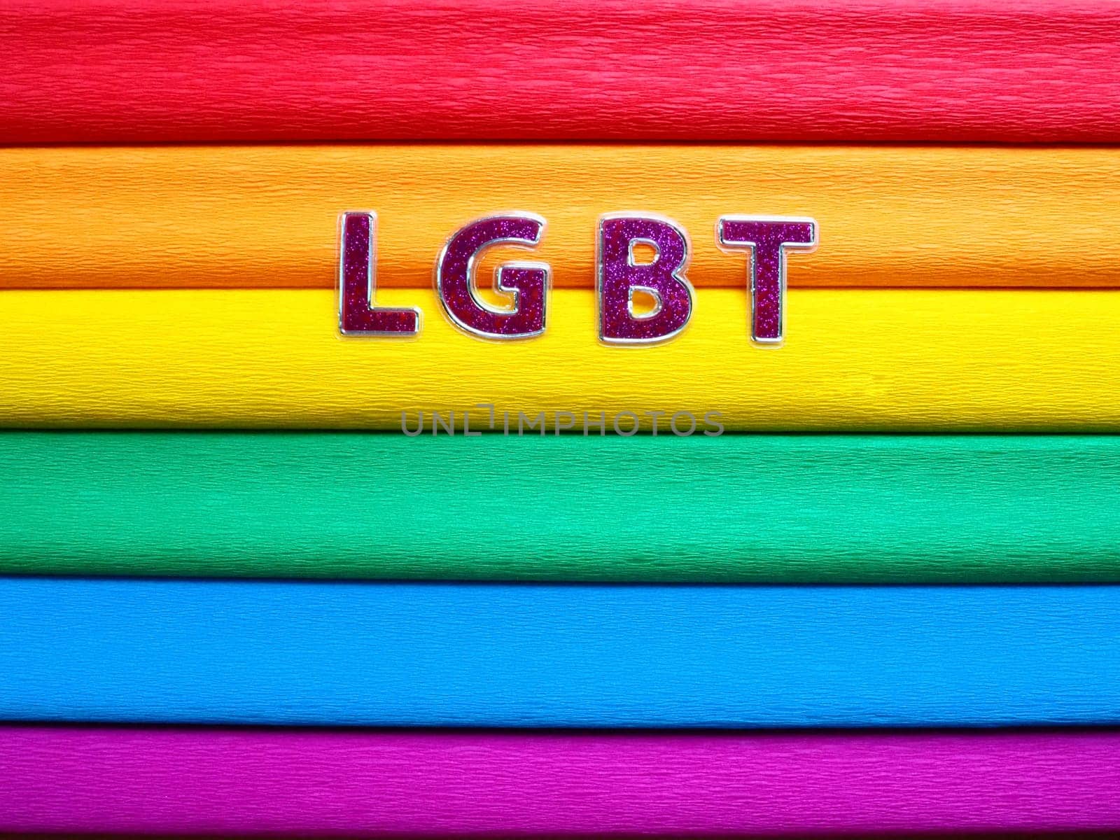 Abbreviation LGBT, letter text. Purple LGBT lettering on the background of the rainbow flag. A Rainbow Flag, the Pride Flag. LGBTQ community symbol. EuroPride 2022.