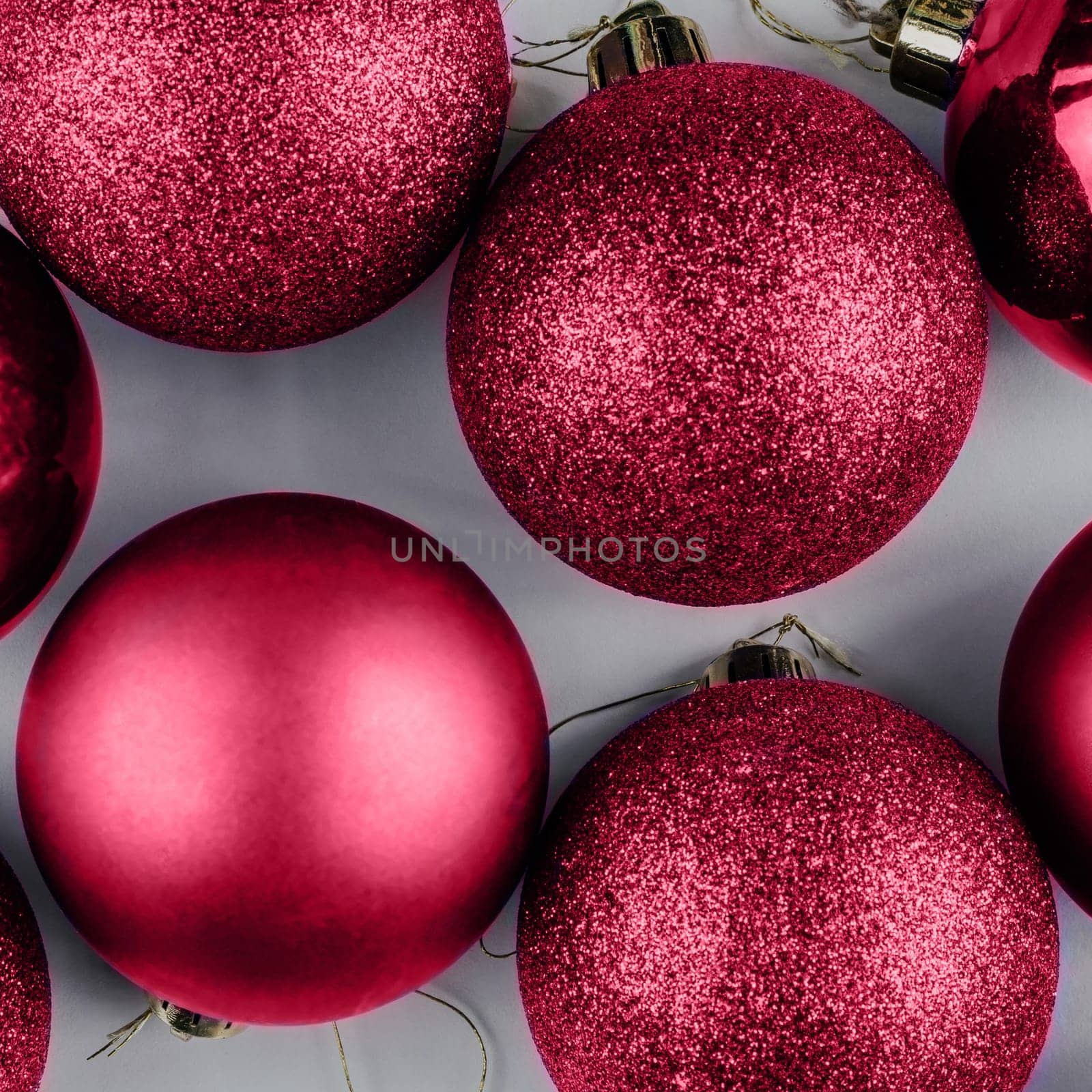 Color of the Year 2023 Viva Magenta. Trendy background of Christmas shiny balls. Fashion carmine shade. Copy space. Square