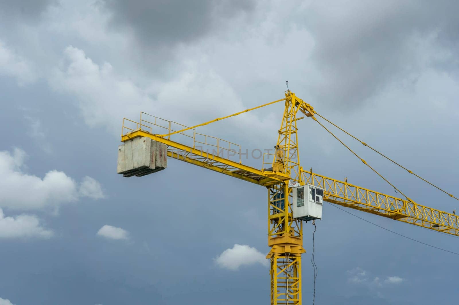 The crane of yellow and overcast sky