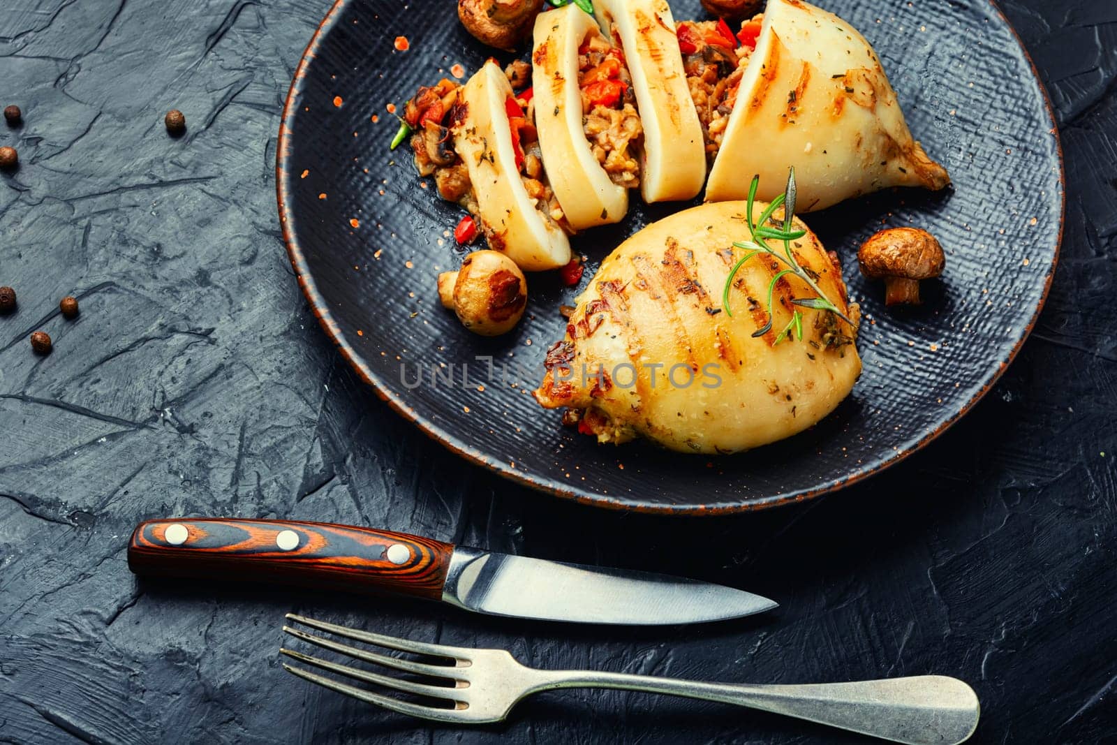 Grilled squids with vegetable stuffing. Stuffed calamari. Mediterranean food