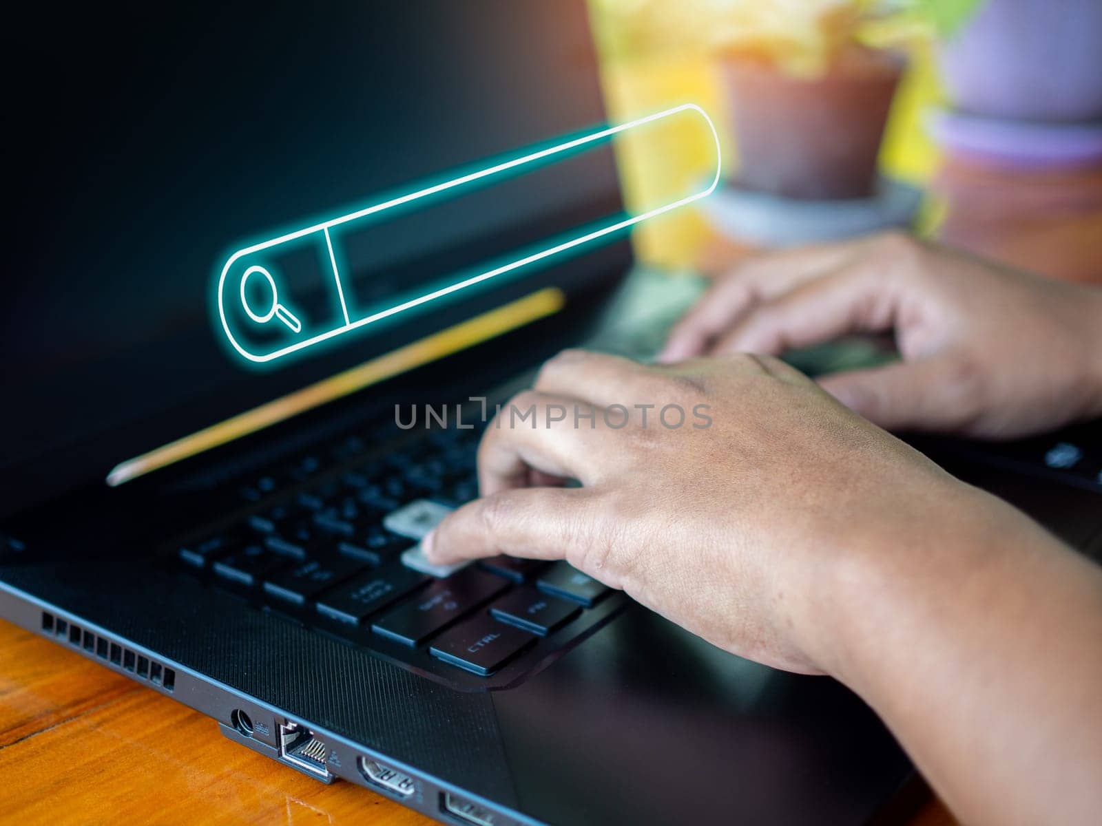 Human hand working on computer and search icon. The concept of searching for information from the internet network.