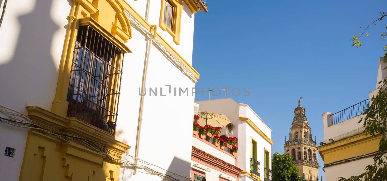 Cordoba historic quarter overview, Andalusia, Spain. Yellow Balcony with wrought iron