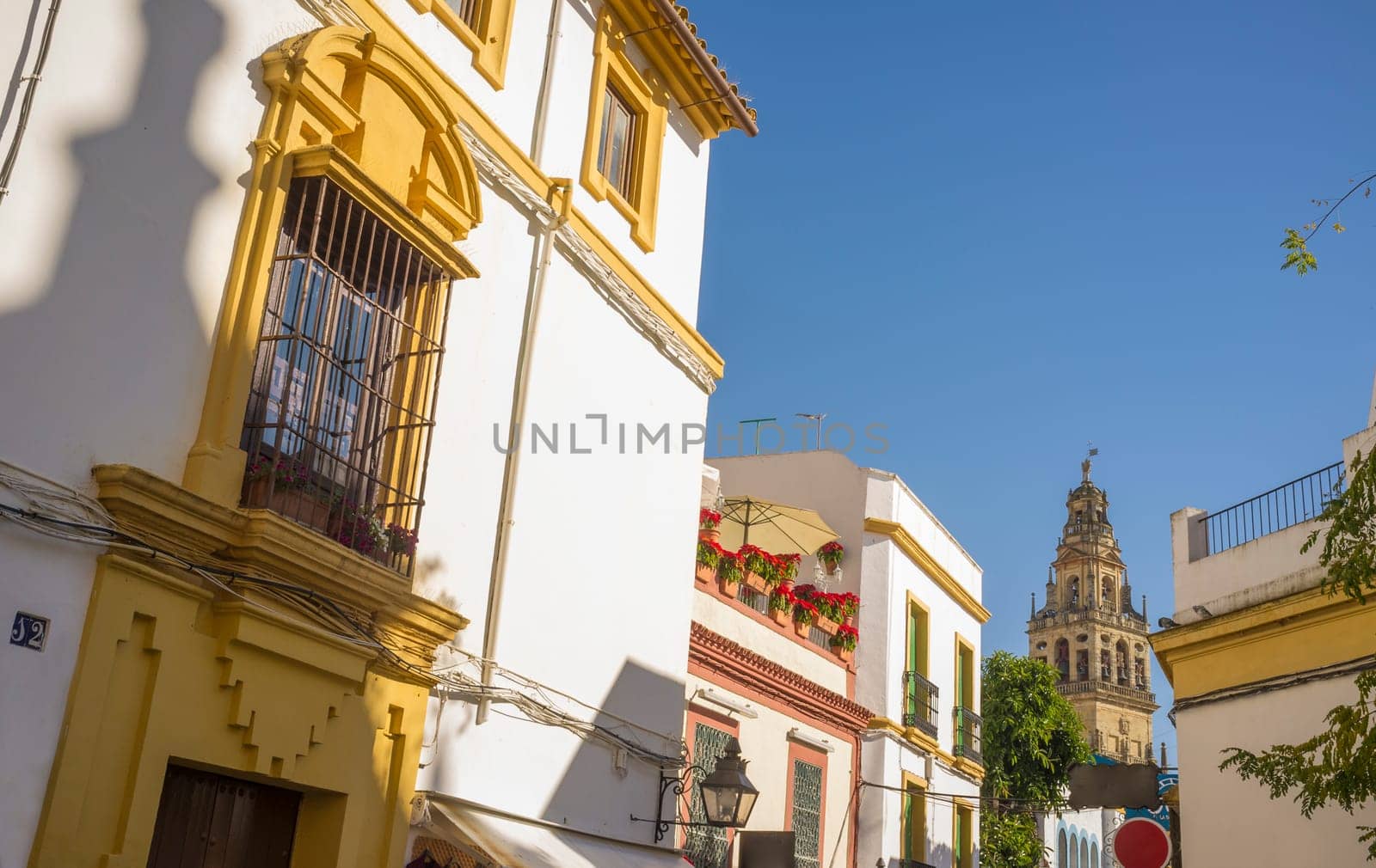Cordoba historic quarter overview, Andalusia, Spain. Yellow Balcony with wrought iron