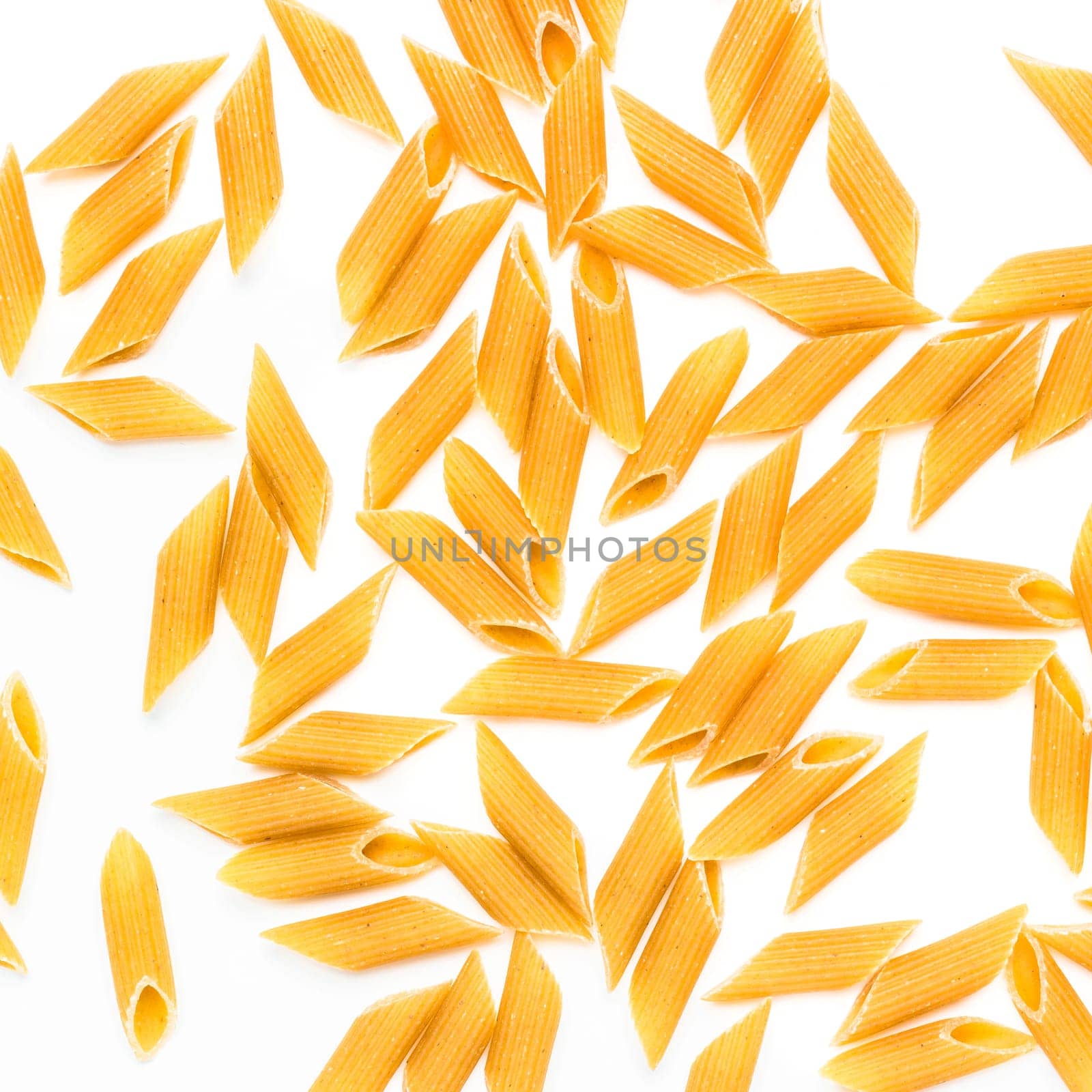 Penne rigate pasta. Pasta on white background. Dry penne rigate pasta isolated over white. Top view.