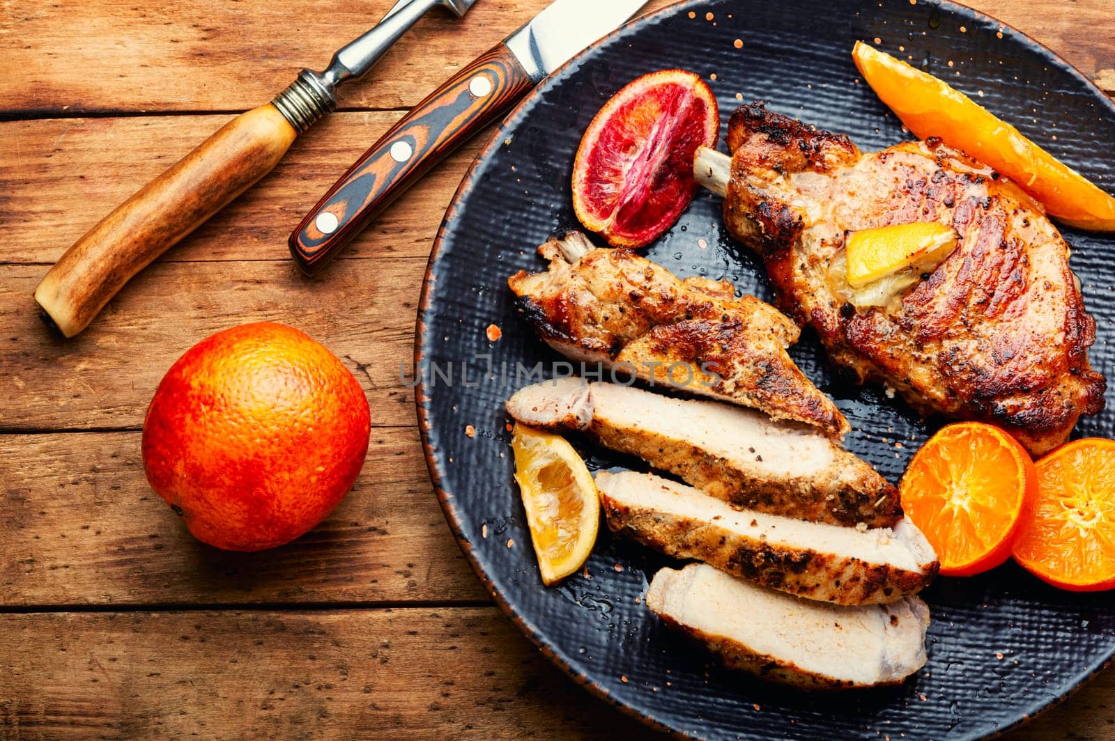 Juicy meat steak grilled in oranges. Meat in citrus marinade. Top view