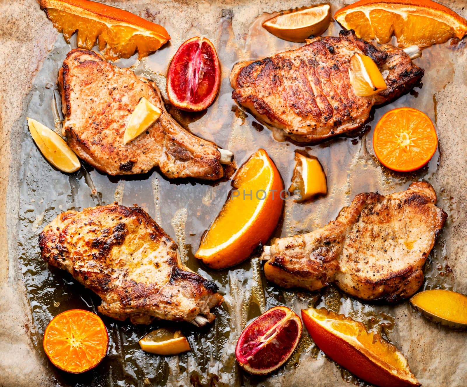 Juicy meat steak grilled in oranges. Meat in citrus marinade. Top view