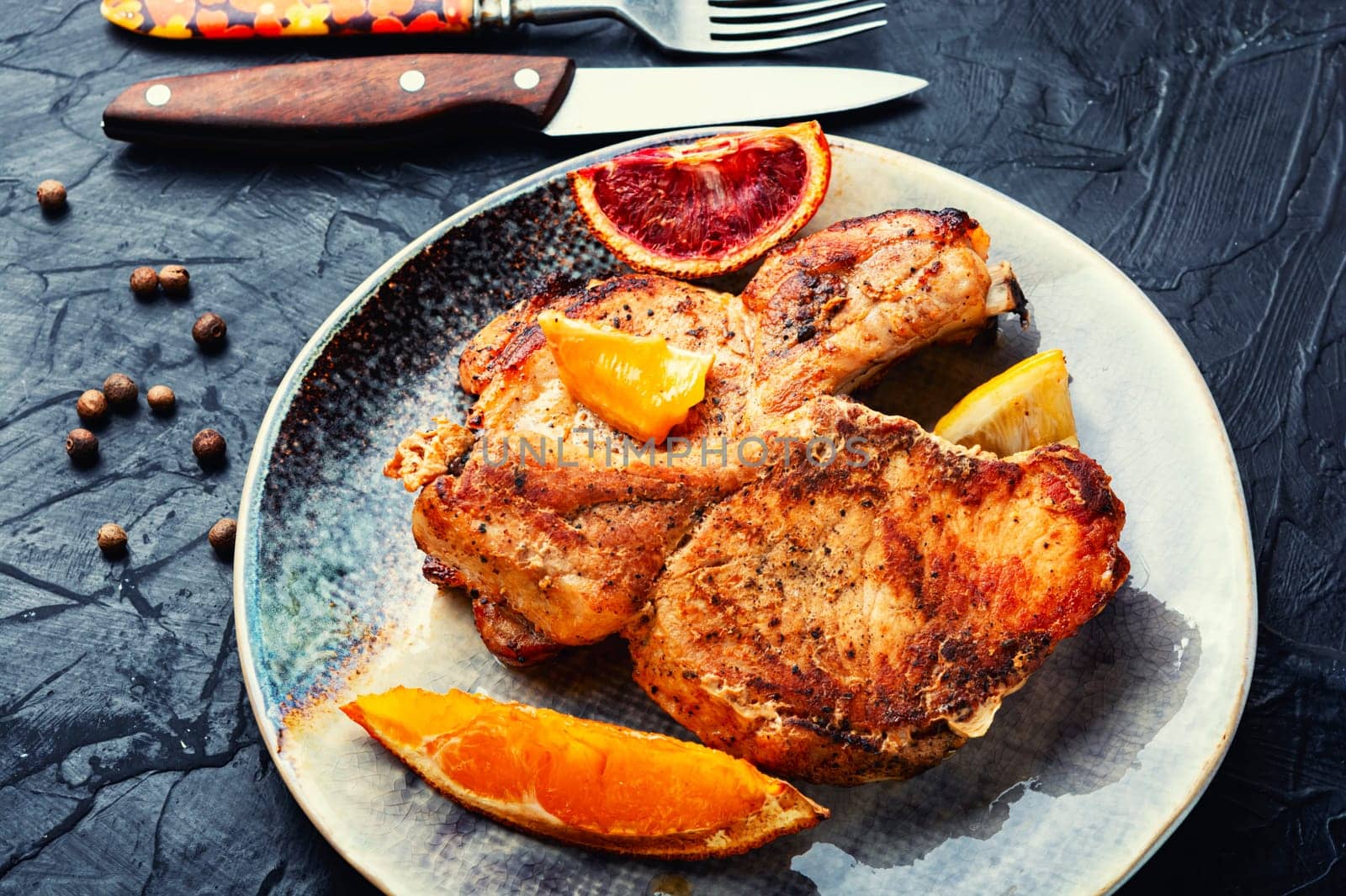 Juicy meat steak grilled in oranges. Meat in citrus marinade. Top view