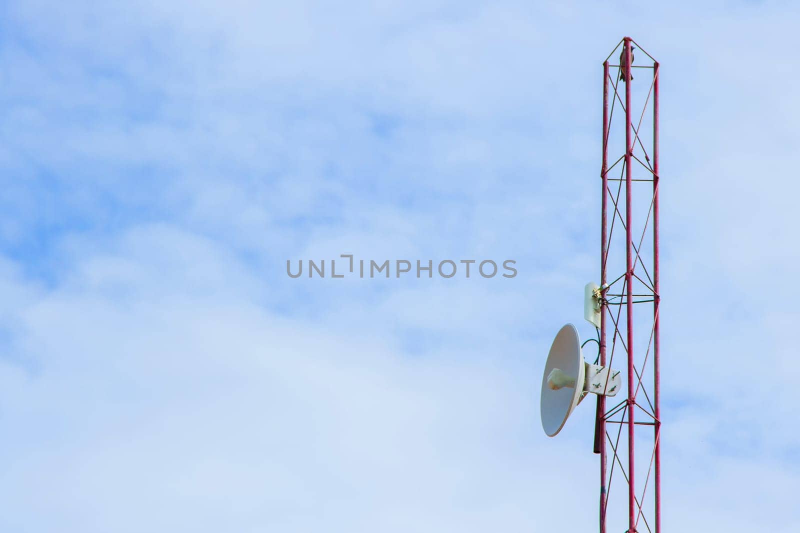 Mobile phone communication tower transmission  signal with blue sky background and antenna