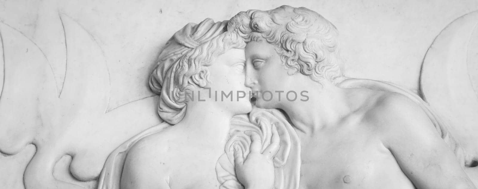 Ornamental relief of a fountain in Florence, Italy. Ancient sculpture with kissing couple. Florentine art 16th Cent.