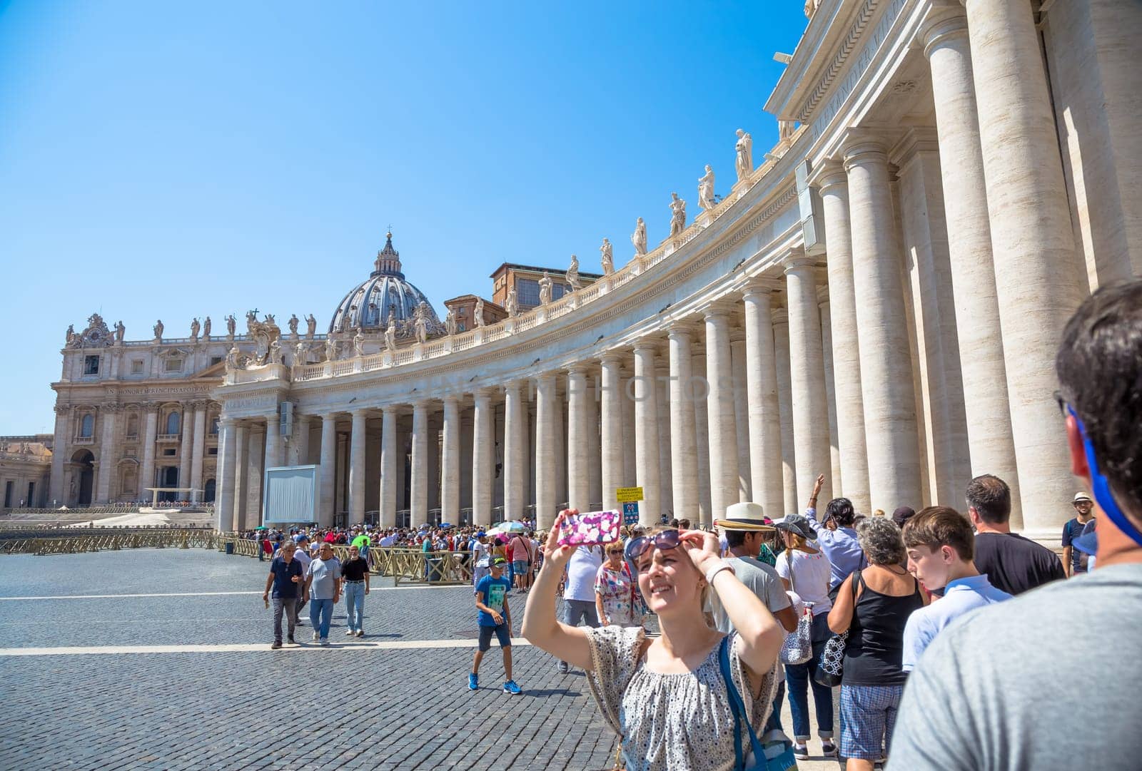ROME, VATICAN STATE - AUGUST 24, 2018: long line of people waiting in front of Saint Peter Basilica entrance. Concept for overtourism and mass-tourism.