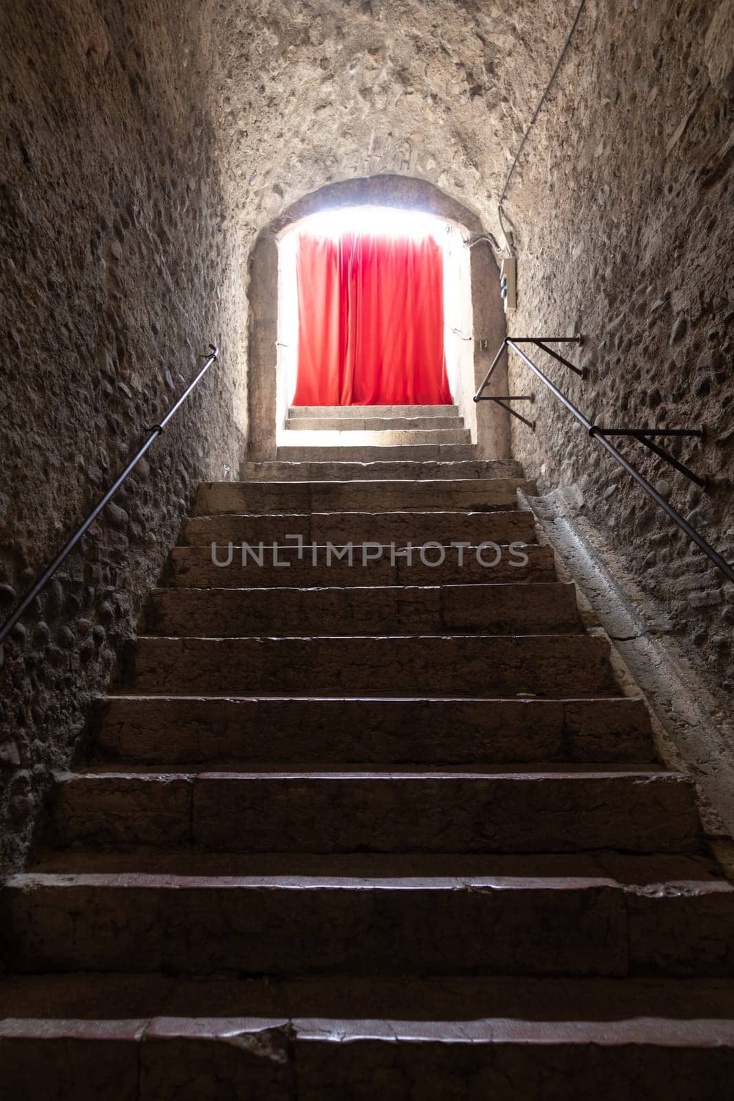 Old corridor with red curtain at the end. Concept for mystery, gothic, escape, hope